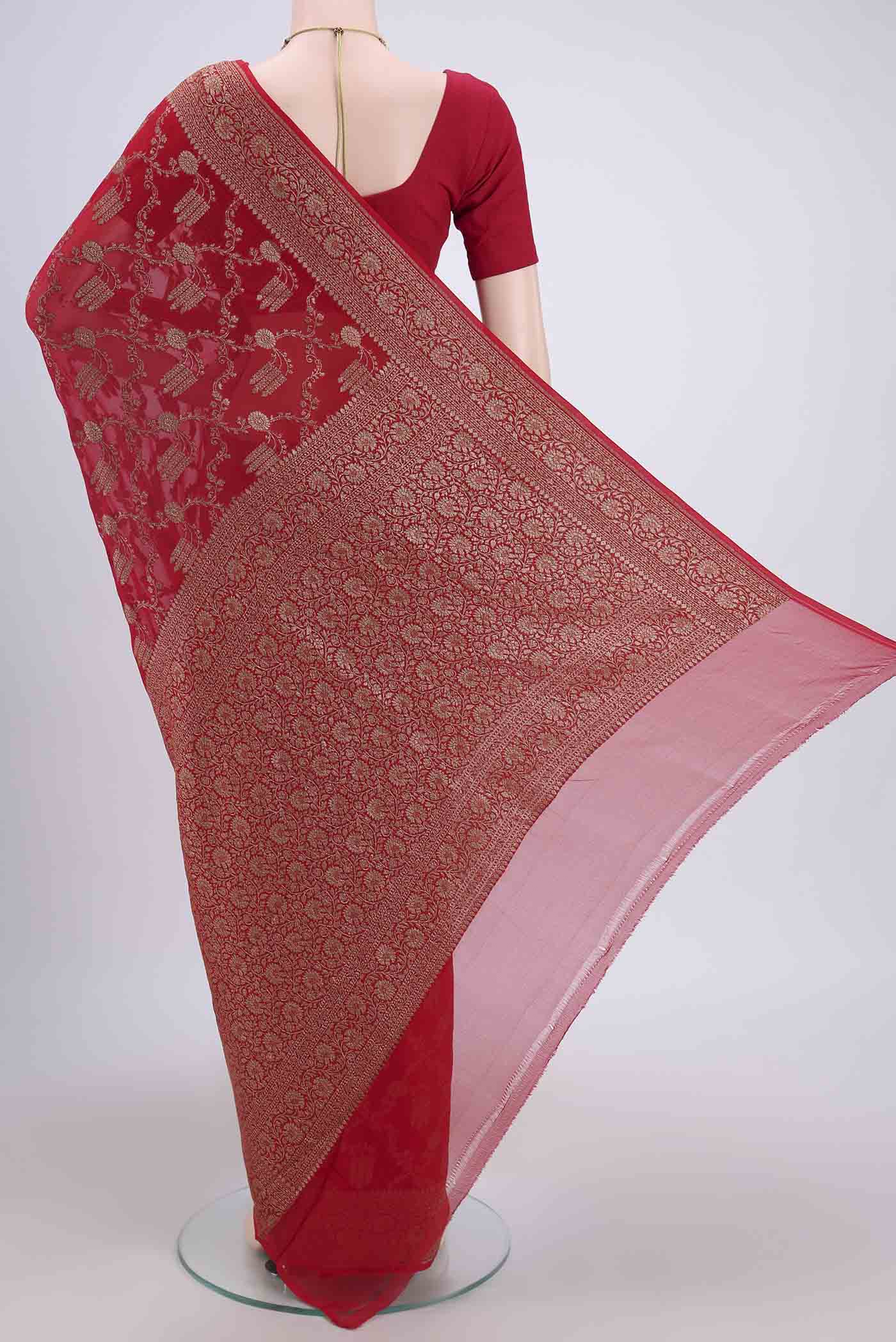 Flat view of Red Banarasi Georgette Saree with Zari Brocade on the body and Zari Border. 