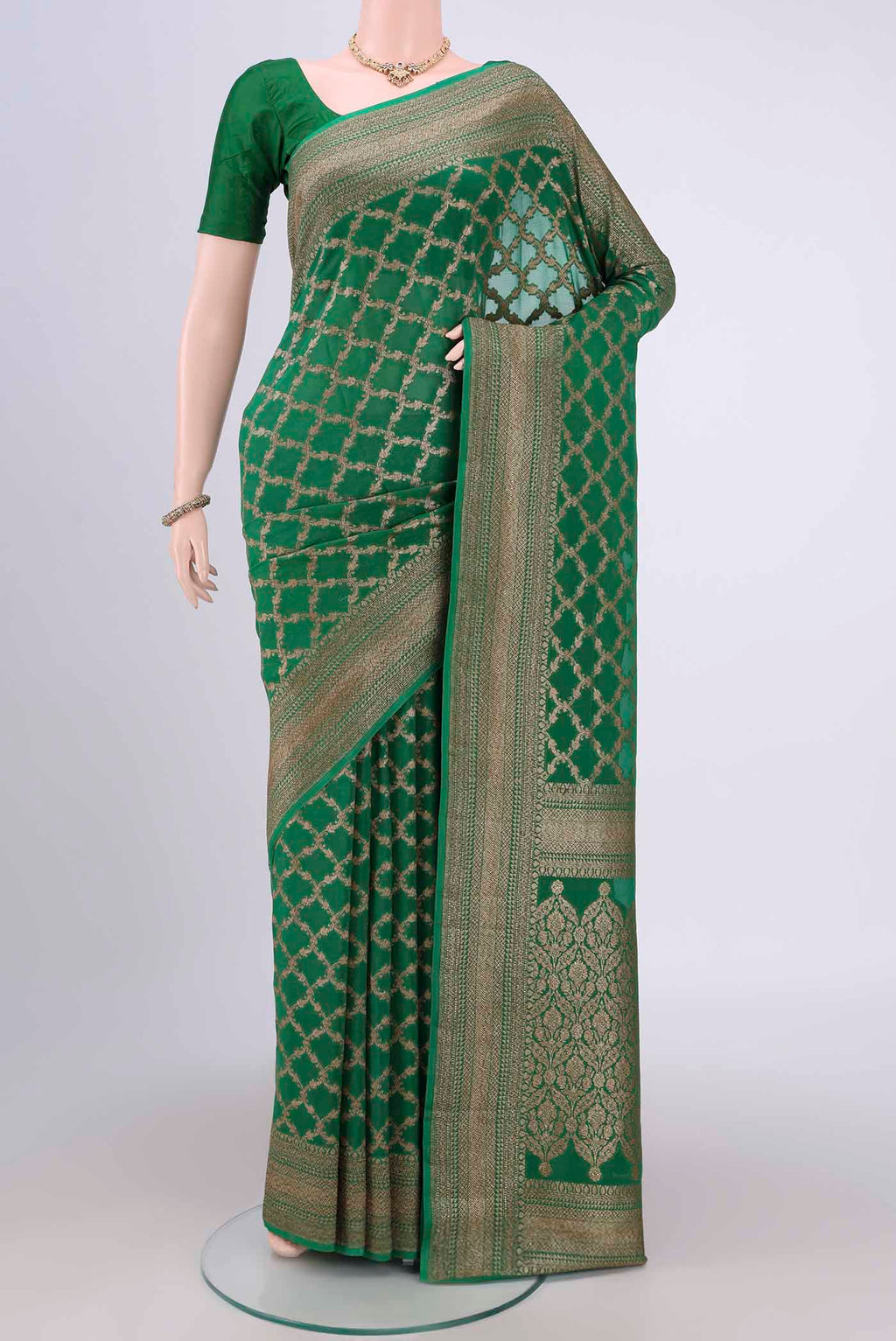 Green Banarasi Georgette Saree with Zari Brocade on the body and Zari Border.  displayed on a mannequin