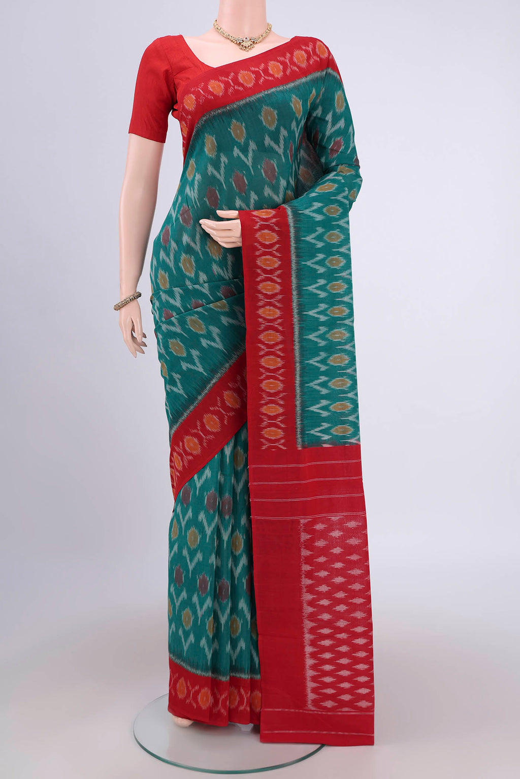 Sea Green Pochampally Cotton Saree with Ikat design on the body and Ikat Border.  displayed on a mannequin