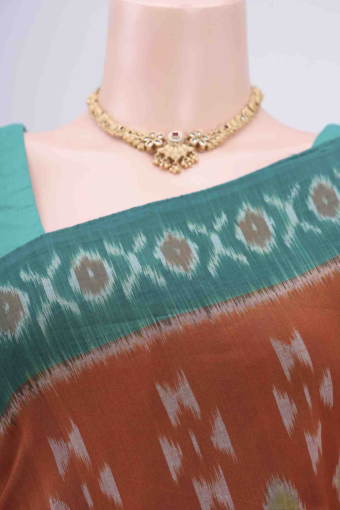 Border image of Rust Pochampally Cotton Saree with Ikat design on the body and Ikat Border. 
