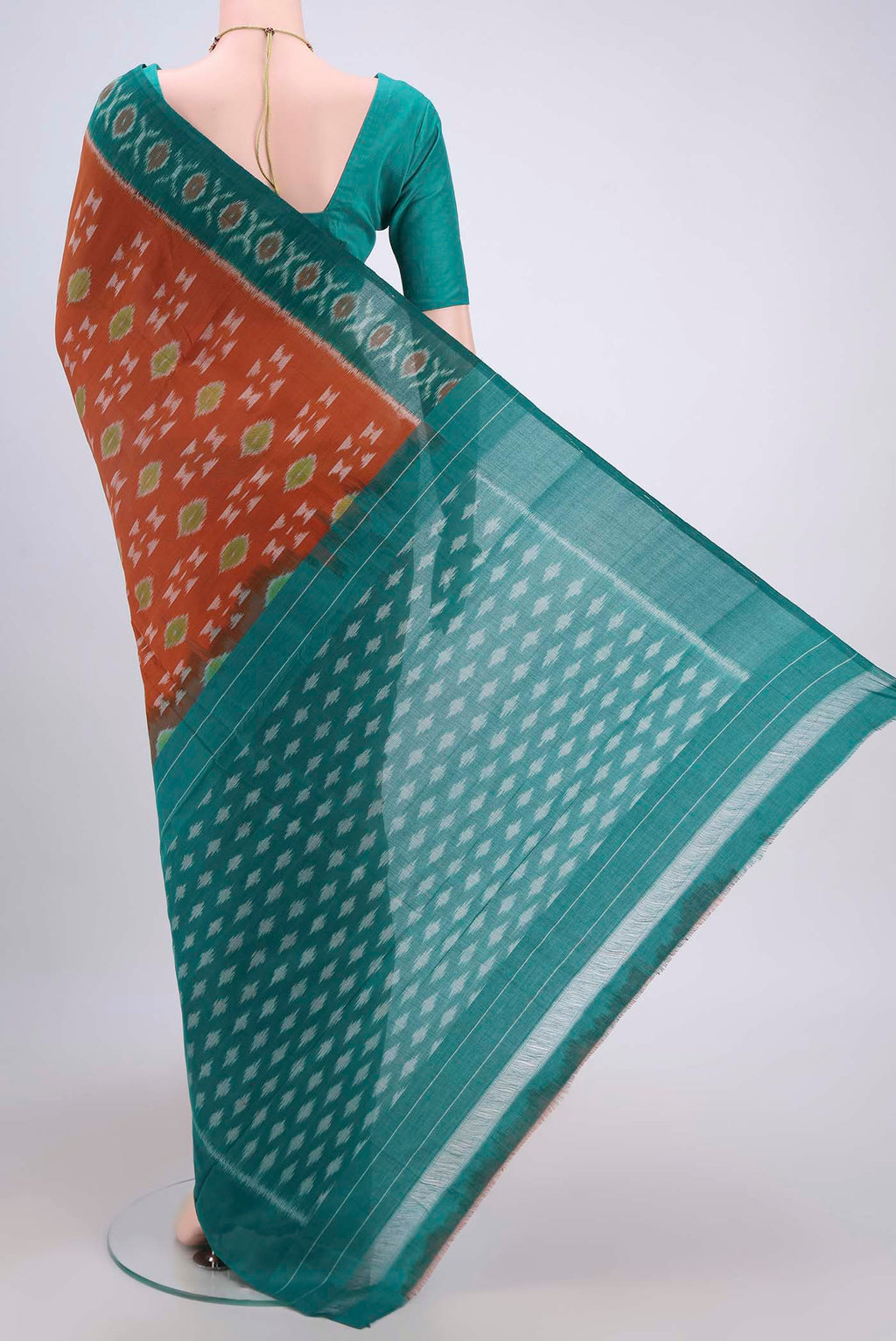 Flat view of Rust Pochampally Cotton Saree with Ikat design on the body and Ikat Border. 