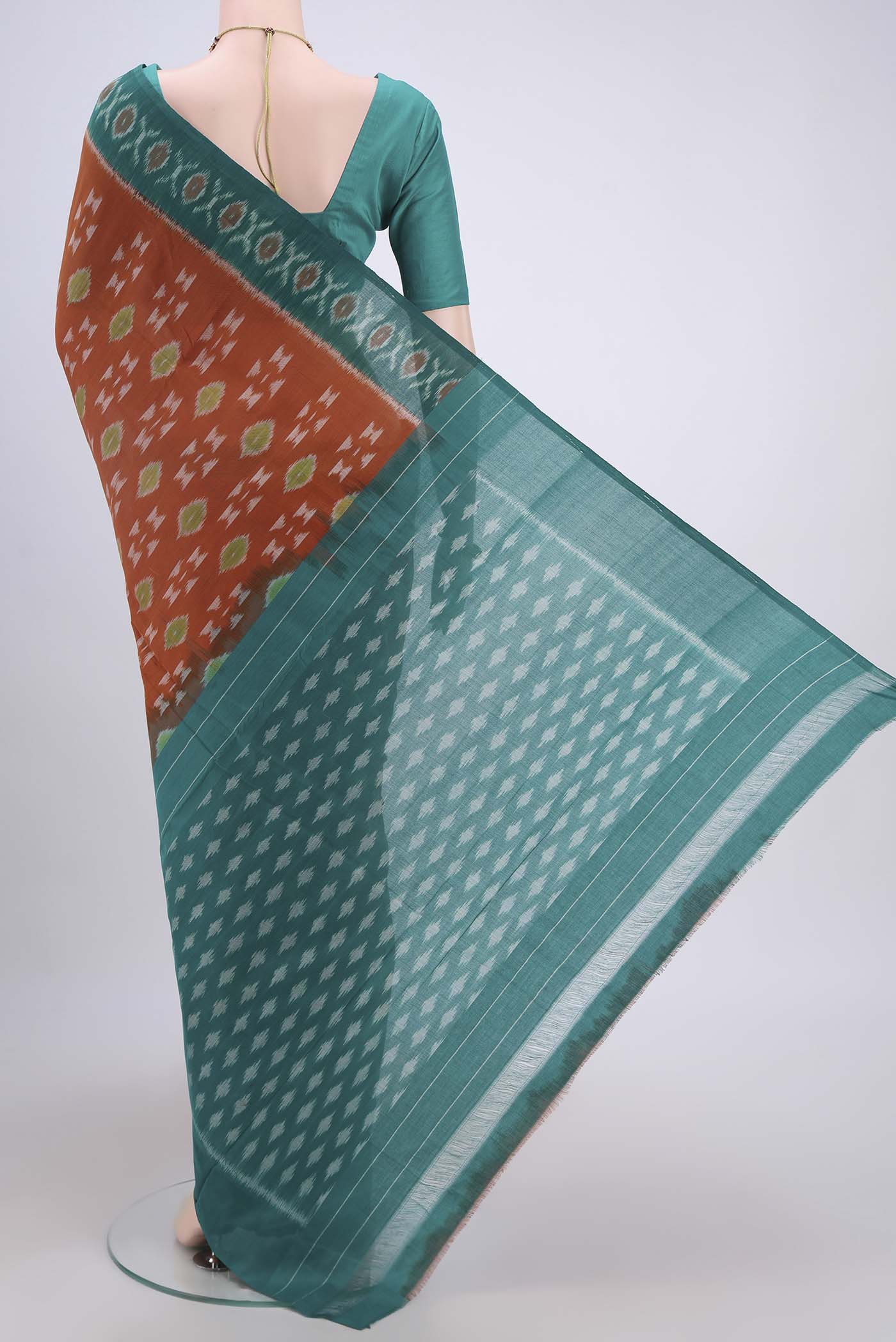 Flat view of Rust Pochampally Cotton Saree with Ikat design on the body and Ikat Border. 