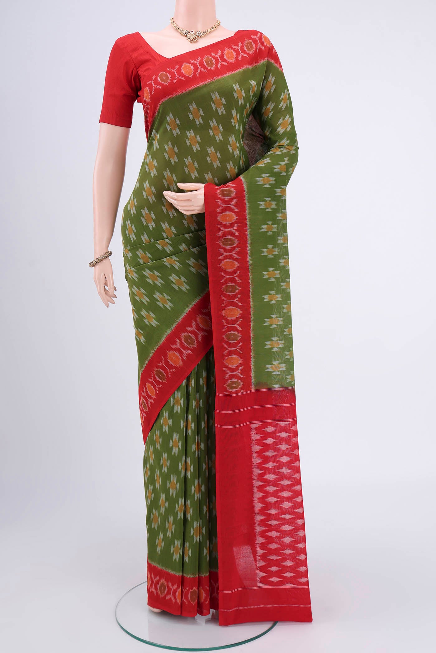 Light Green Pochampally Cotton Saree with Ikat design on the body and Ikat Border.  displayed on a mannequin