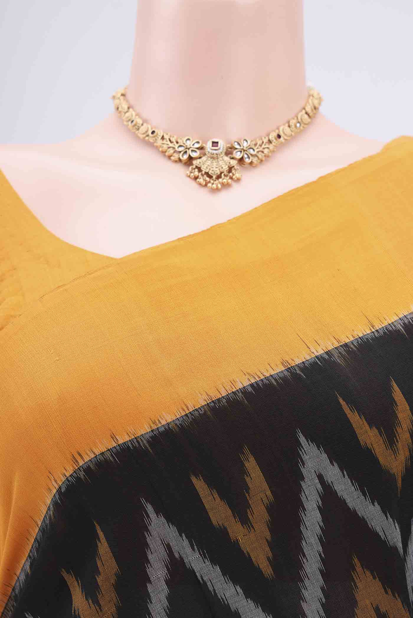 Border image of Black Pochampally Cotton Saree with Ikat design on the body and Ikat Border. 