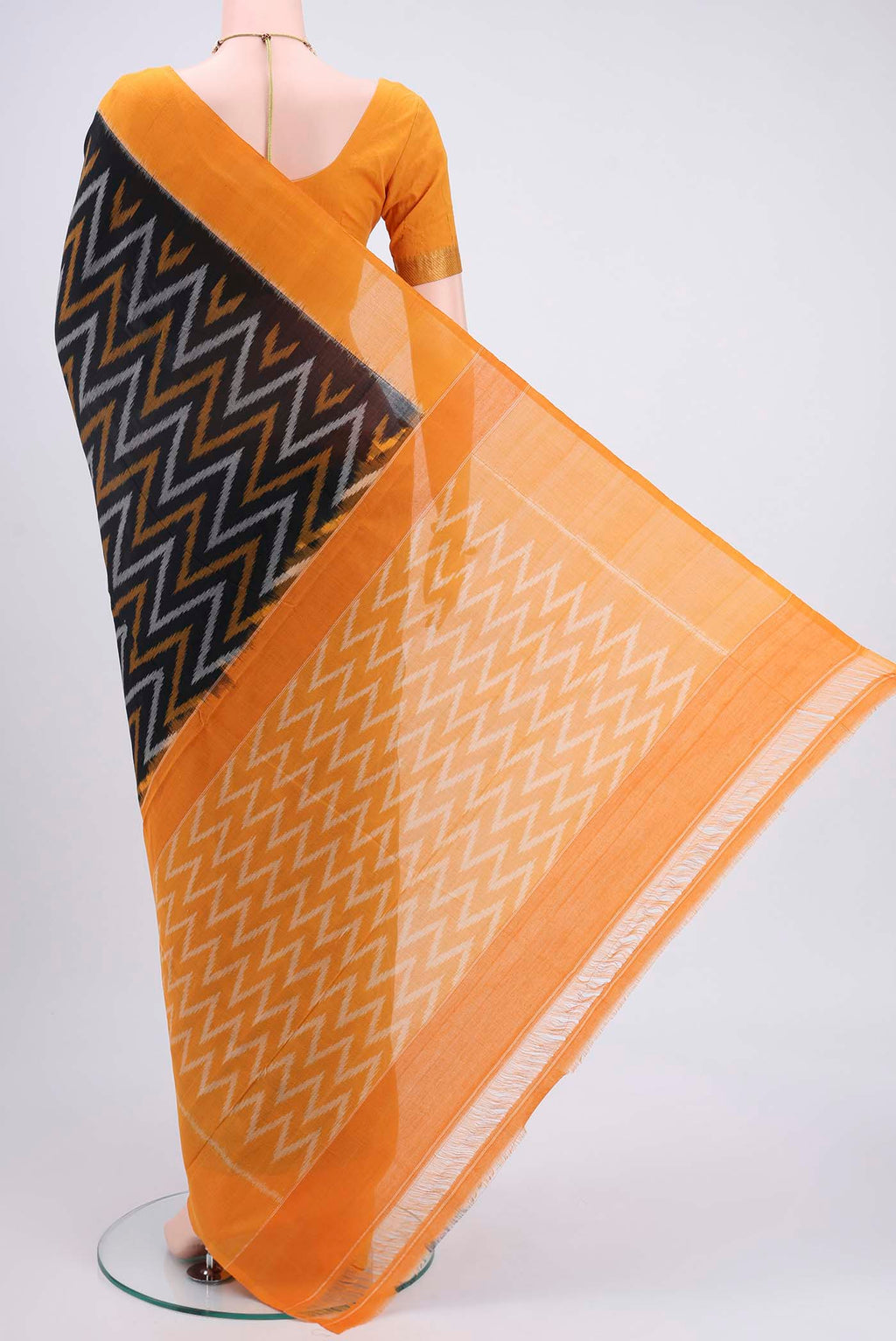 Flat view of Black Pochampally Cotton Saree with Ikat design on the body and Ikat Border. 