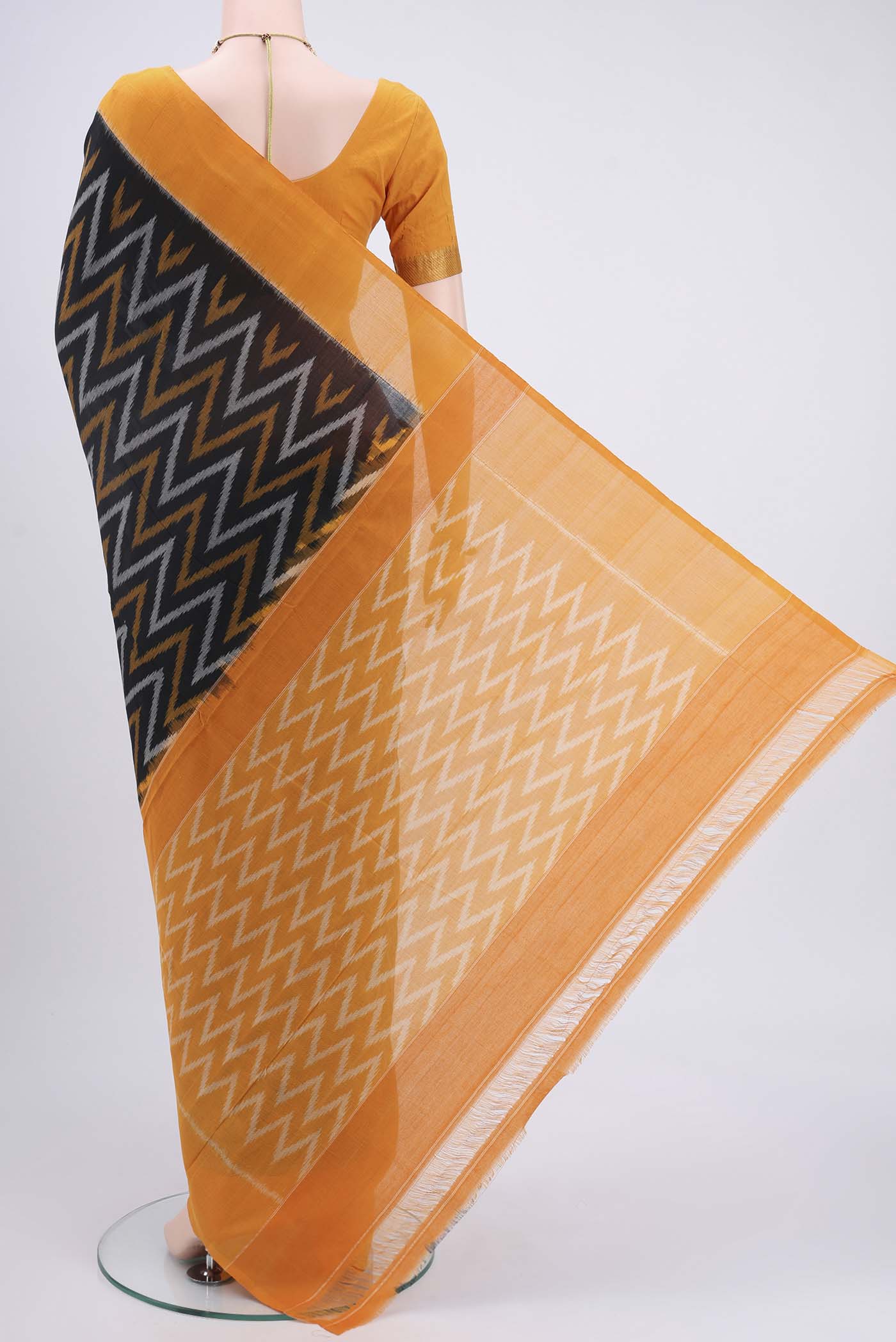 Flat view of Black Pochampally Cotton Saree with Ikat design on the body and Ikat Border. 