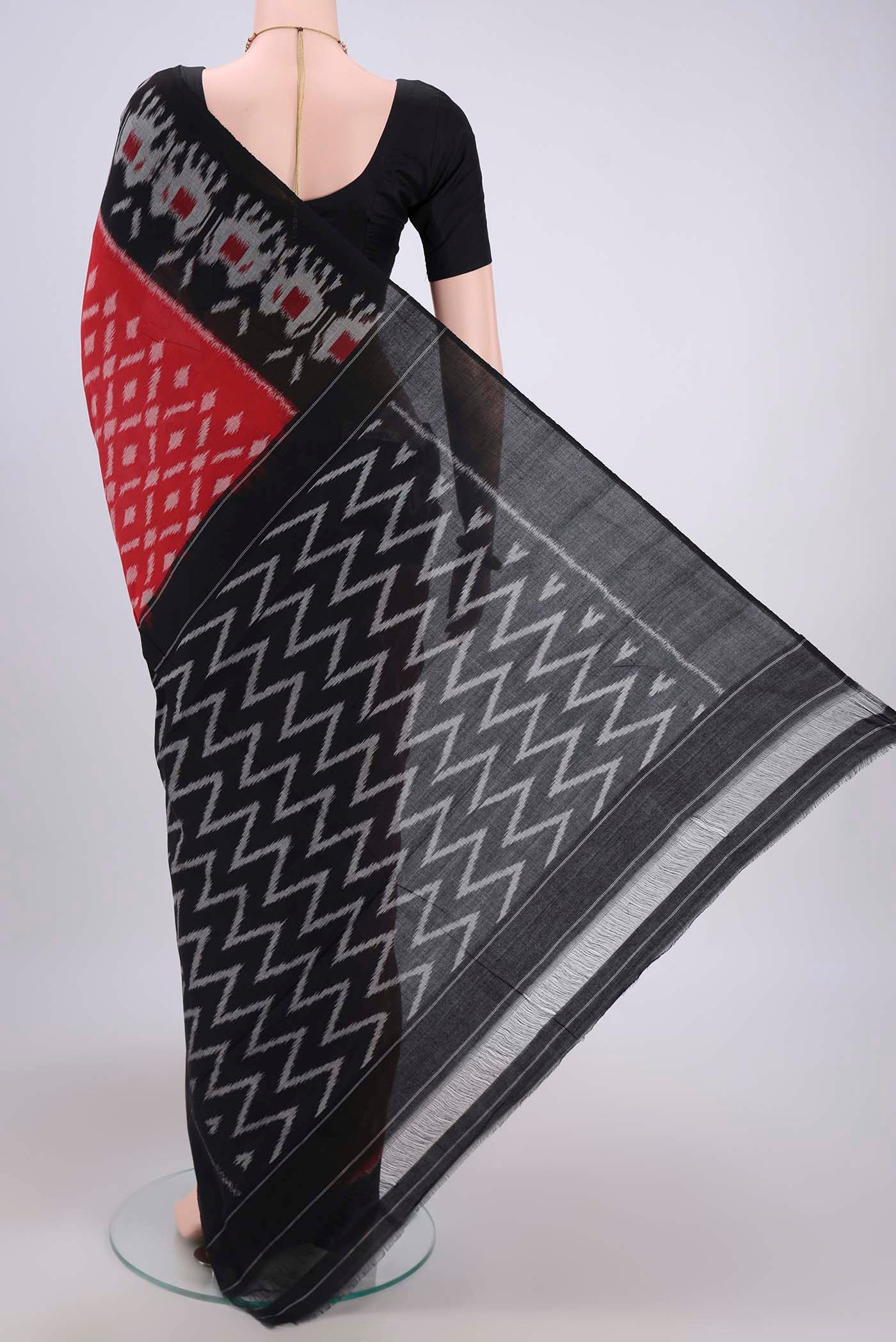 Flat view of Red Pochampally Cotton Saree with Ikat design on the body and Ikat Border. 