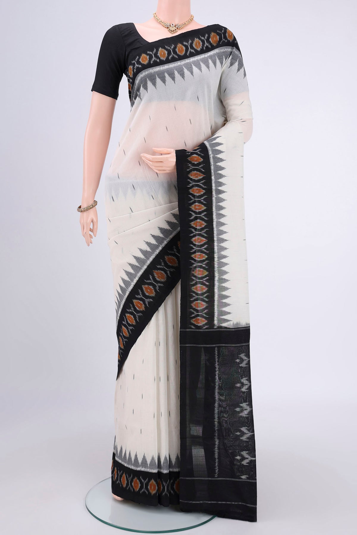 Off White Dual Tone Pochampally Cotton Saree with Ikat design on the body and Ikat Border.  displayed on a mannequin