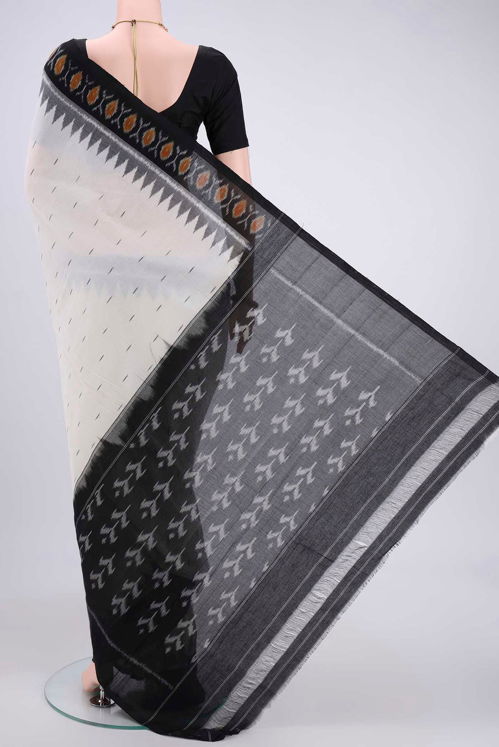 Flat view of Off White Dual Tone Pochampally Cotton Saree with Ikat design on the body and Ikat Border. 