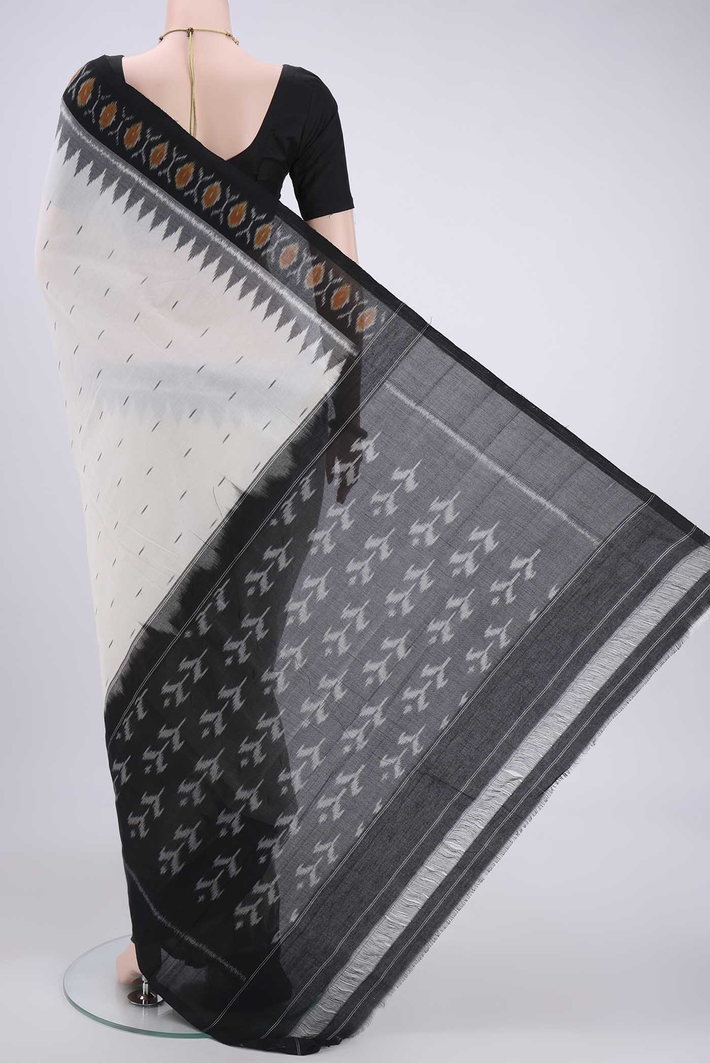 Flat view of Off White Dual Tone Pochampally Cotton Saree with Ikat design on the body and Ikat Border. 