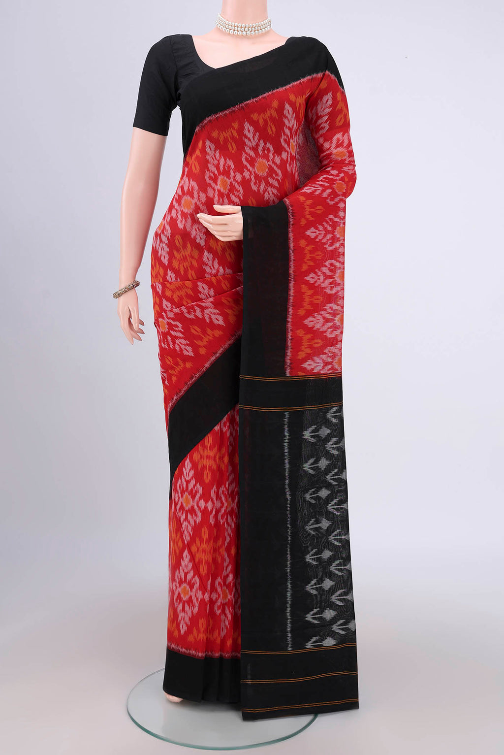 Red Pochampally Cotton Saree with Ikat design on the body and Ikat Border.  displayed on a mannequin