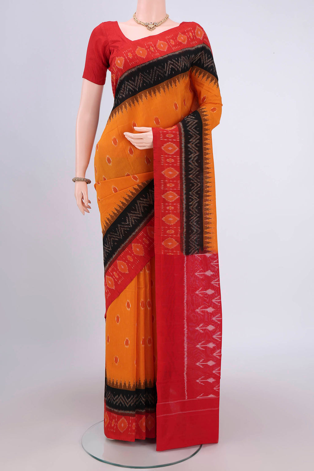 Mustard Pochampally Cotton Saree with Ikat design on the body and Ikat Border.  displayed on a mannequin