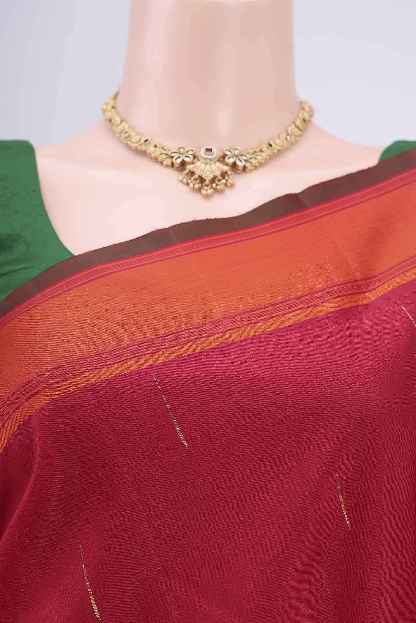 Border image of Maroon Dual Tone Kanjivaram Silk Saree with Zari Butta on the body and Plain Border. 