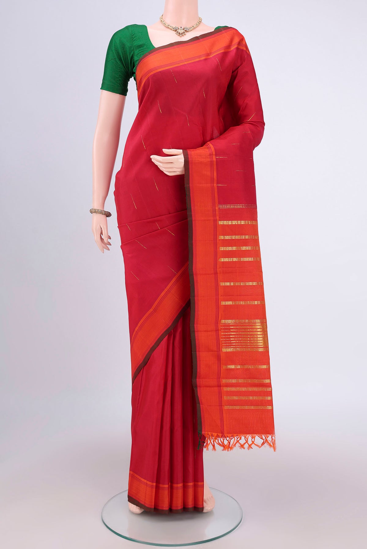 Maroon Dual Tone Kanjivaram Silk Saree with Zari Butta on the body and Plain Border.  displayed on a mannequin