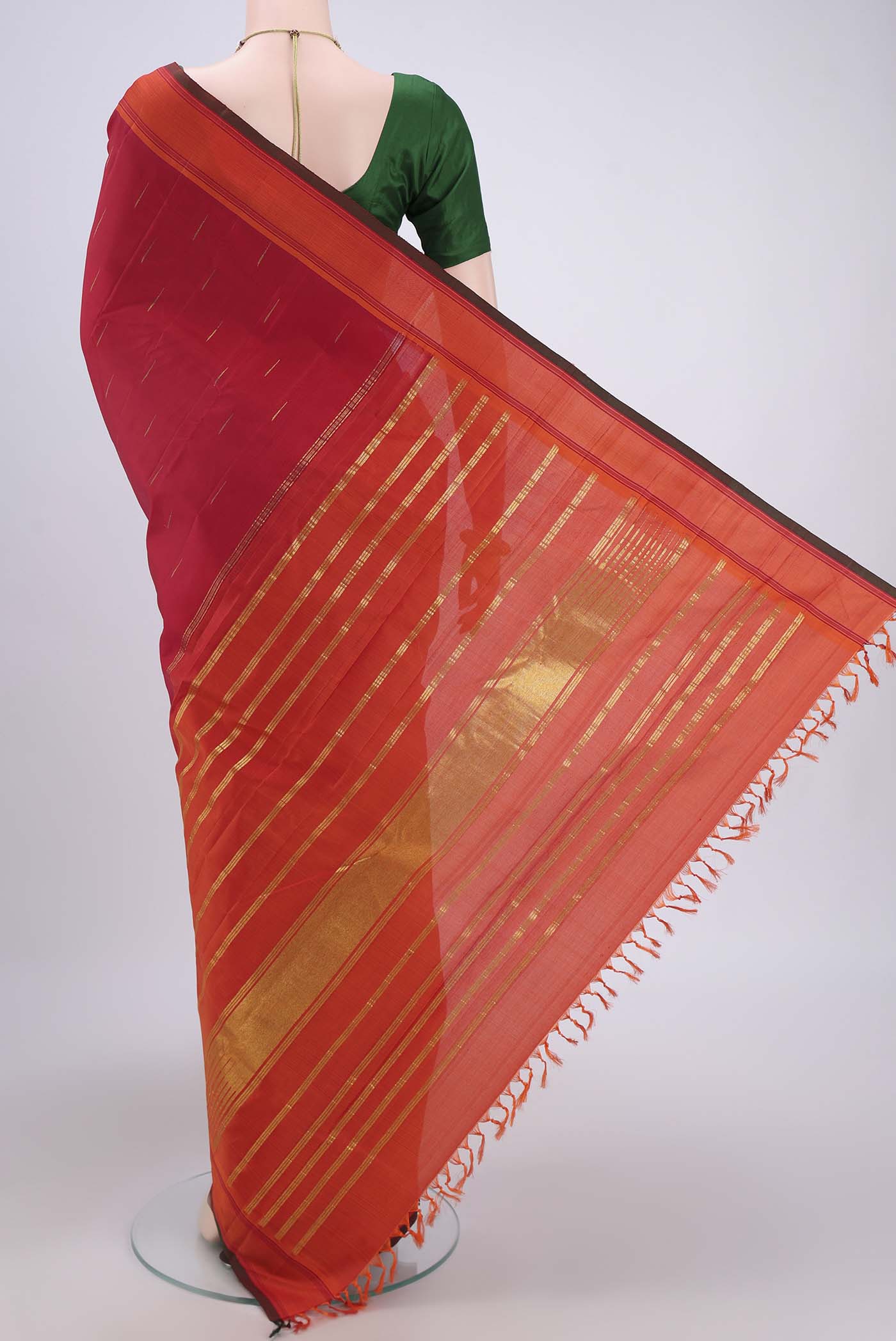 Flat view of Maroon Dual Tone Kanjivaram Silk Saree with Zari Butta on the body and Plain Border. 