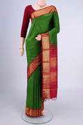 Green Kanjivaram Silk Saree with Plain Body and Zari Border.  displayed on a mannequin
