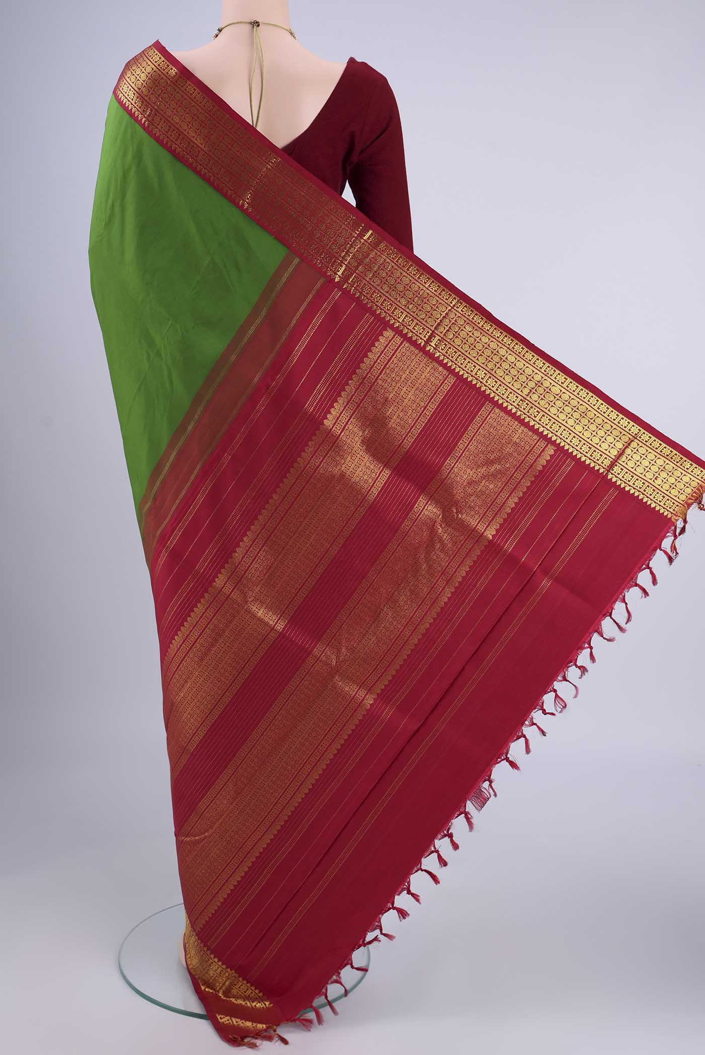 Flat view of Green Kanjivaram Silk Saree with Plain Body and Zari Border. 