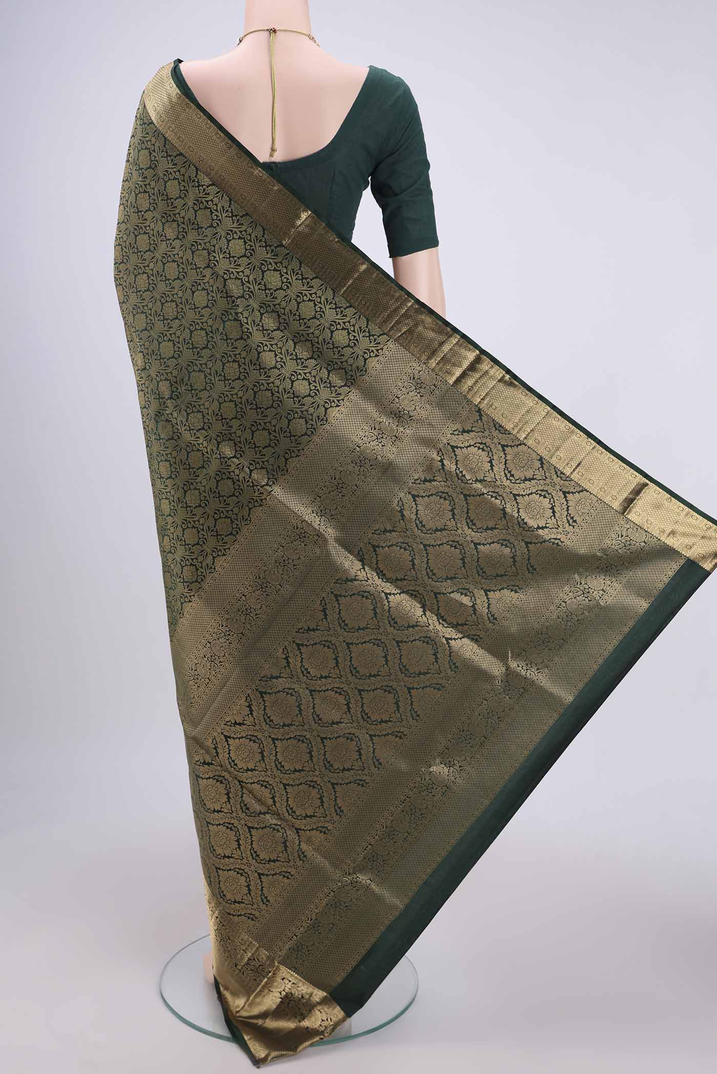 Flat view of Bottle Green Soft Silk Saree with Zari Brocade on the body and Zari Border. 