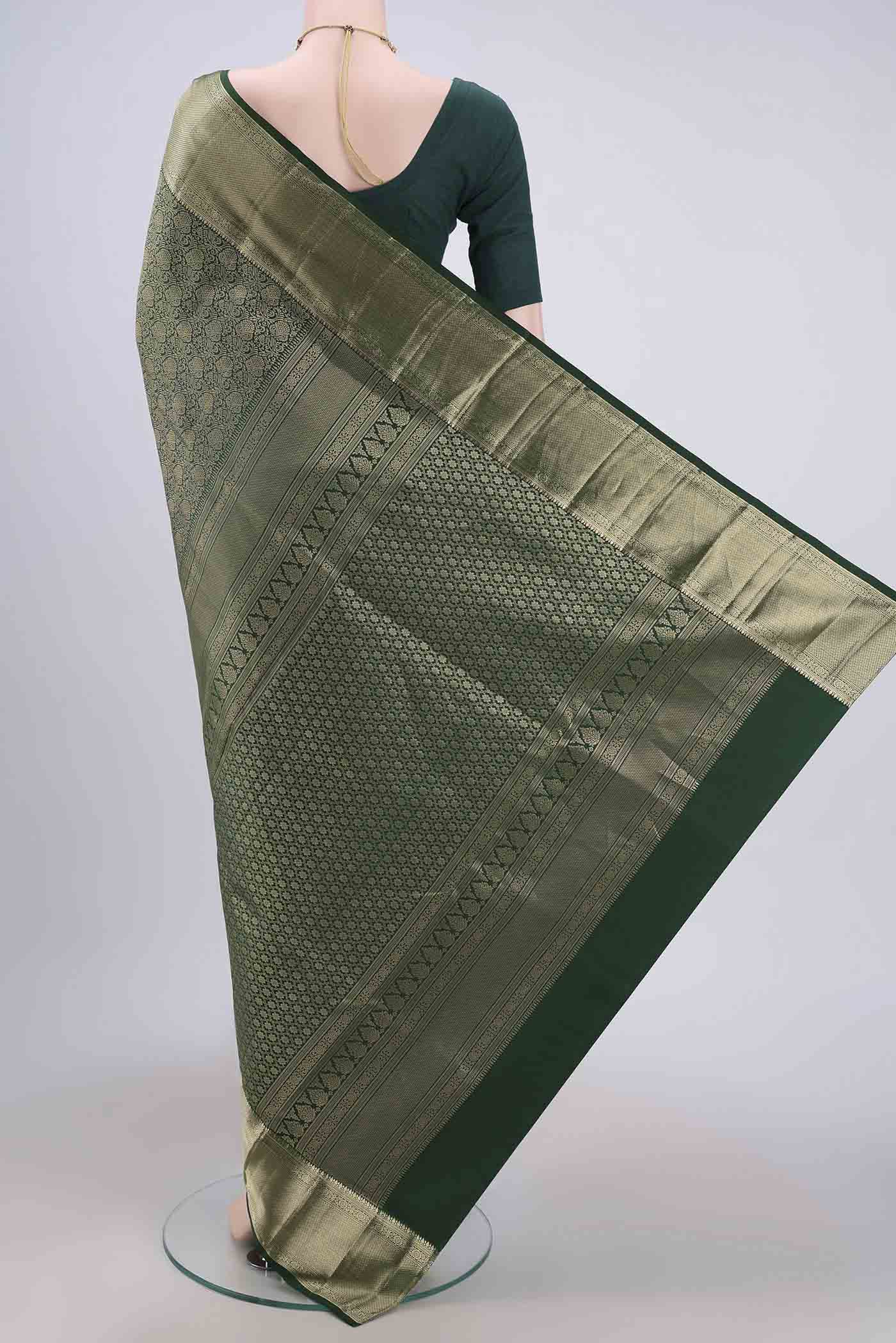 Flat view of Bottle Green Soft Silk Saree with Zari Brocade on the body and Zari Border. 