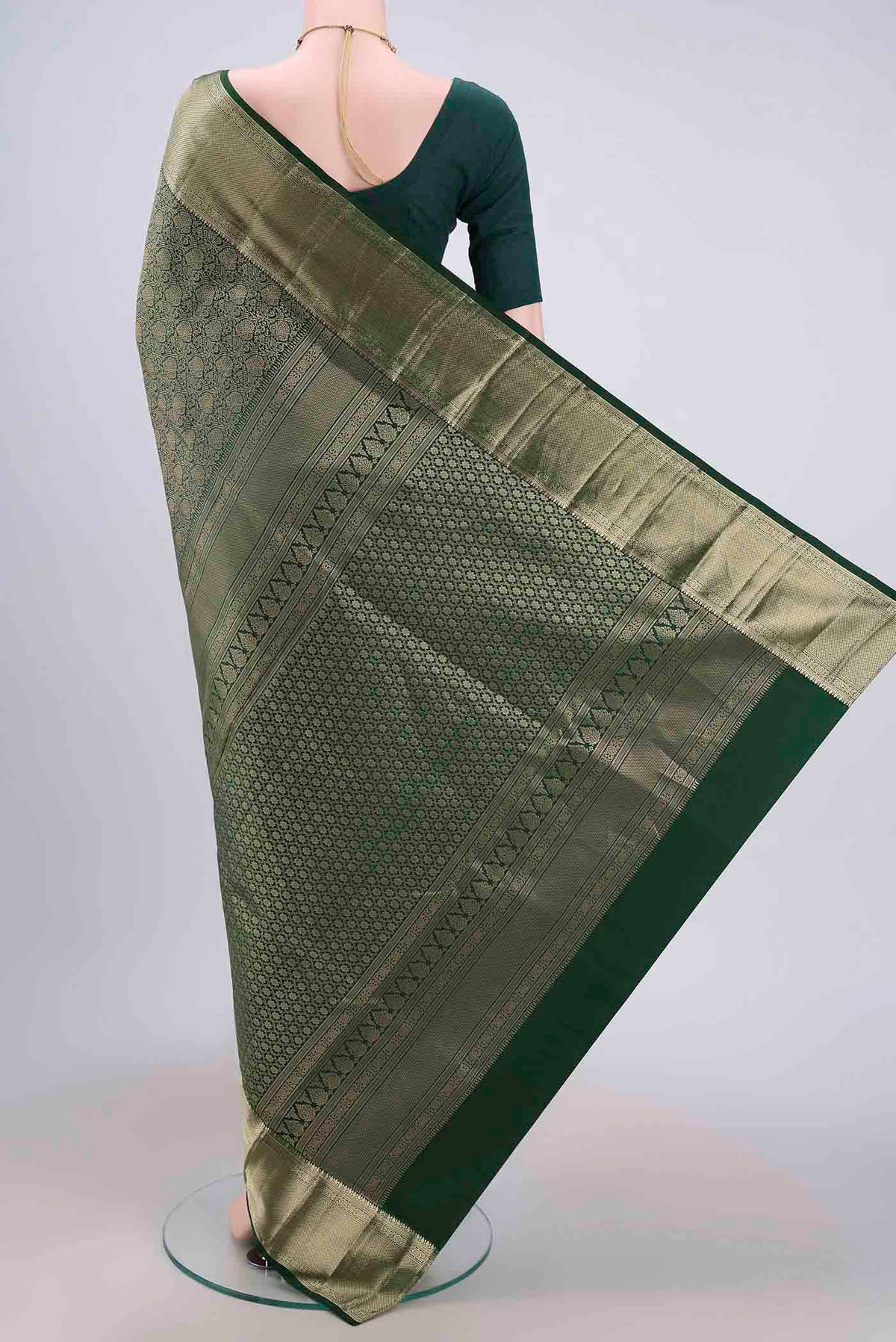 Flat view of Bottle Green Soft Silk Saree with Zari Brocade on the body and Zari Border. 