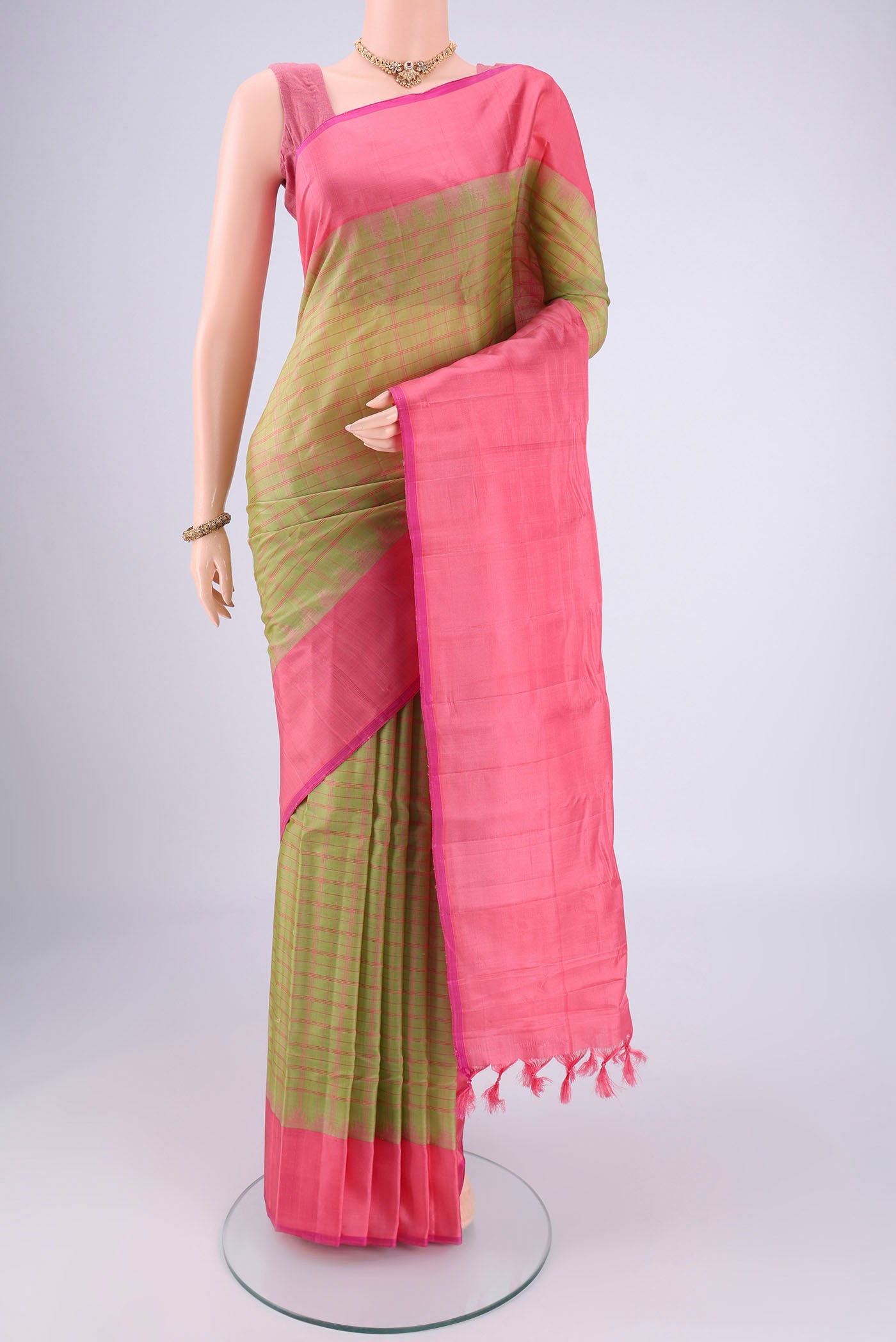 Green Gadwal Silk Saree with Checked design on the body and Plain Border.  displayed on a mannequin