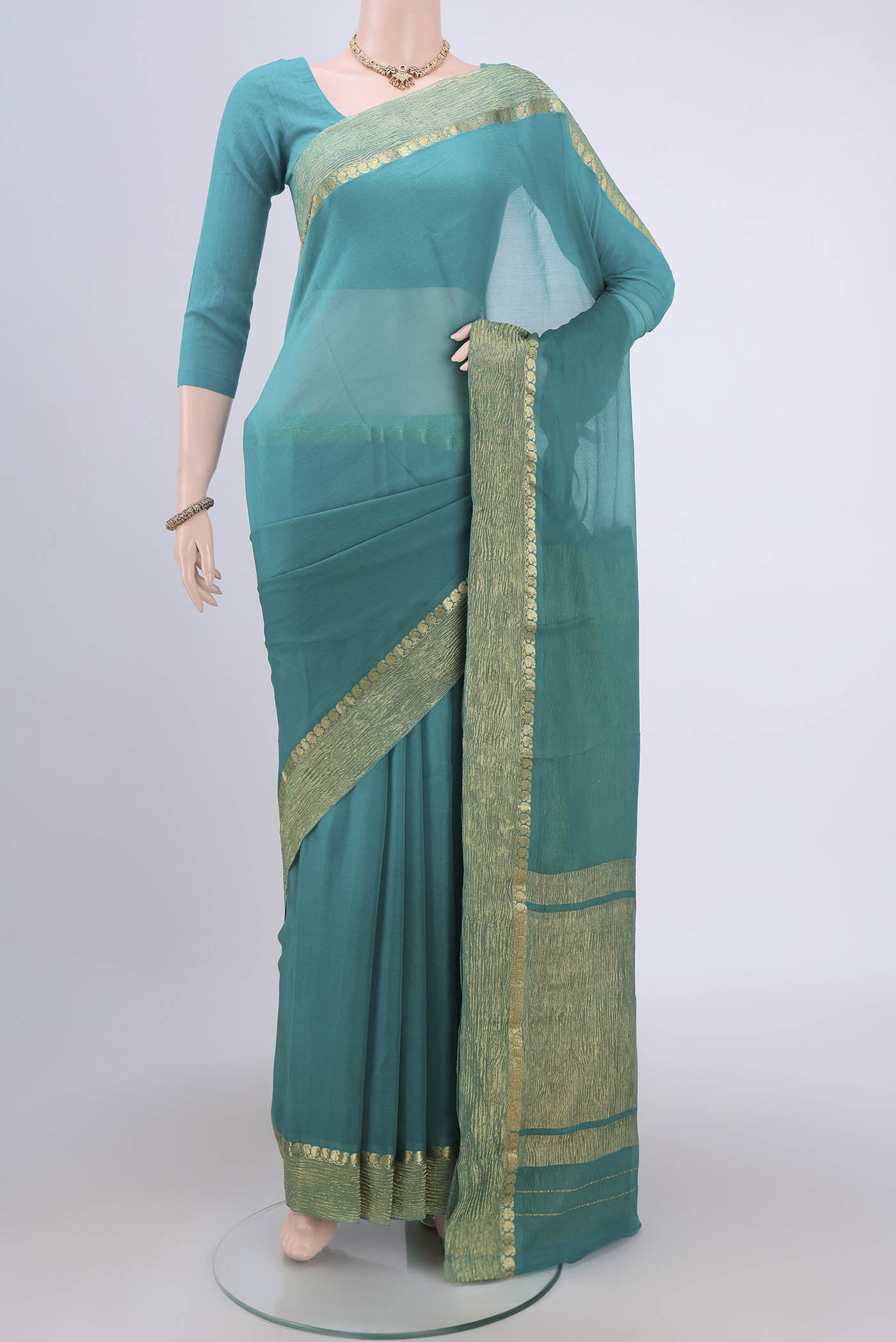 Sea Green Mysore Chiffon Saree with Plain Body and Zari Border.  displayed on a mannequin