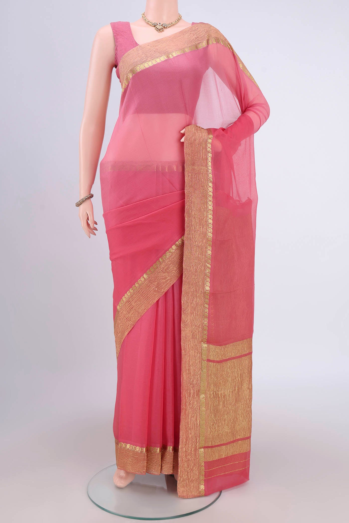 Peach Mysore Chiffon Saree with Half And Half on the body and Zari Border.  displayed on a mannequin