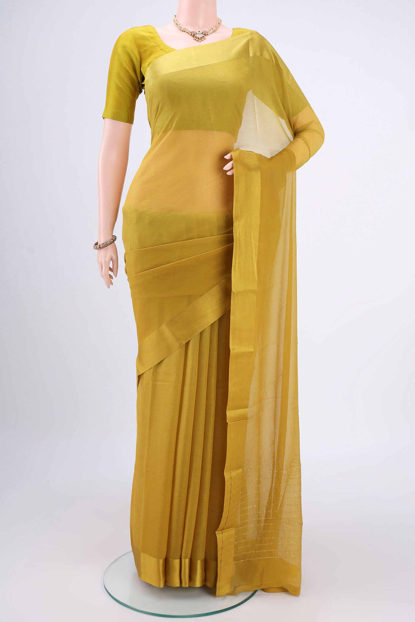 Mehandi Green Mysore Chiffon Saree with Plain Body and Satin Border.  displayed on a mannequin