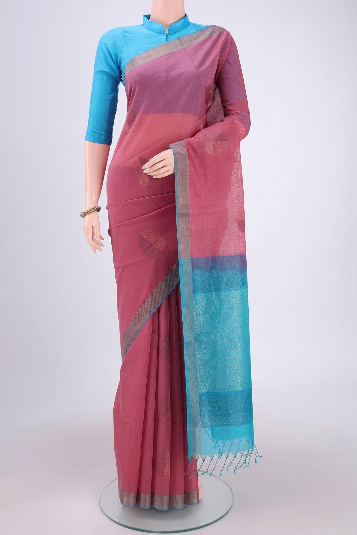 Rose Gold Kora Cotton Saree with Zari Butta on the body and Plain Border.  displayed on a mannequin