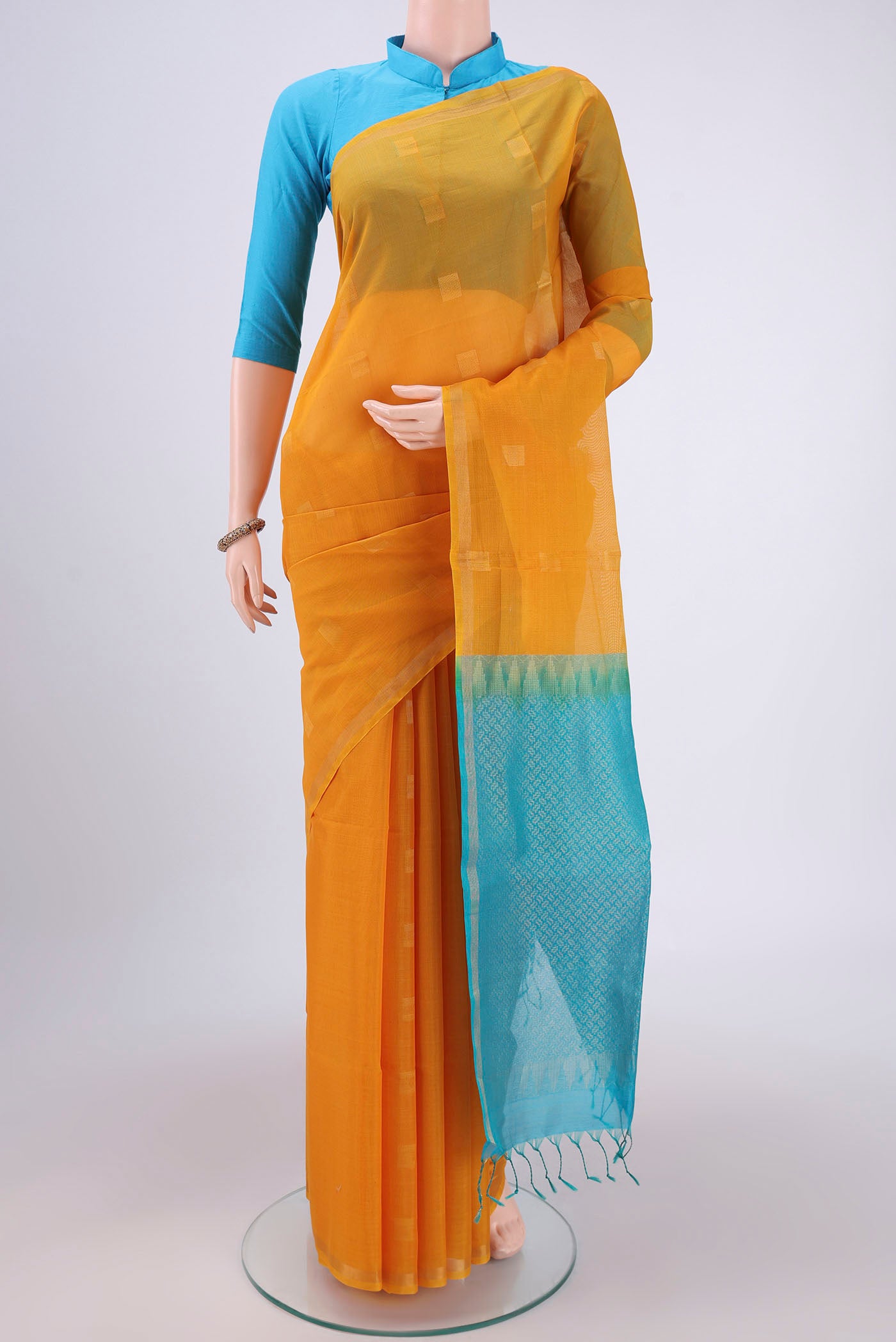 Yellow Silk Cotton Saree with Zari Butta on the body and Thin Zari Line.  displayed on a mannequin