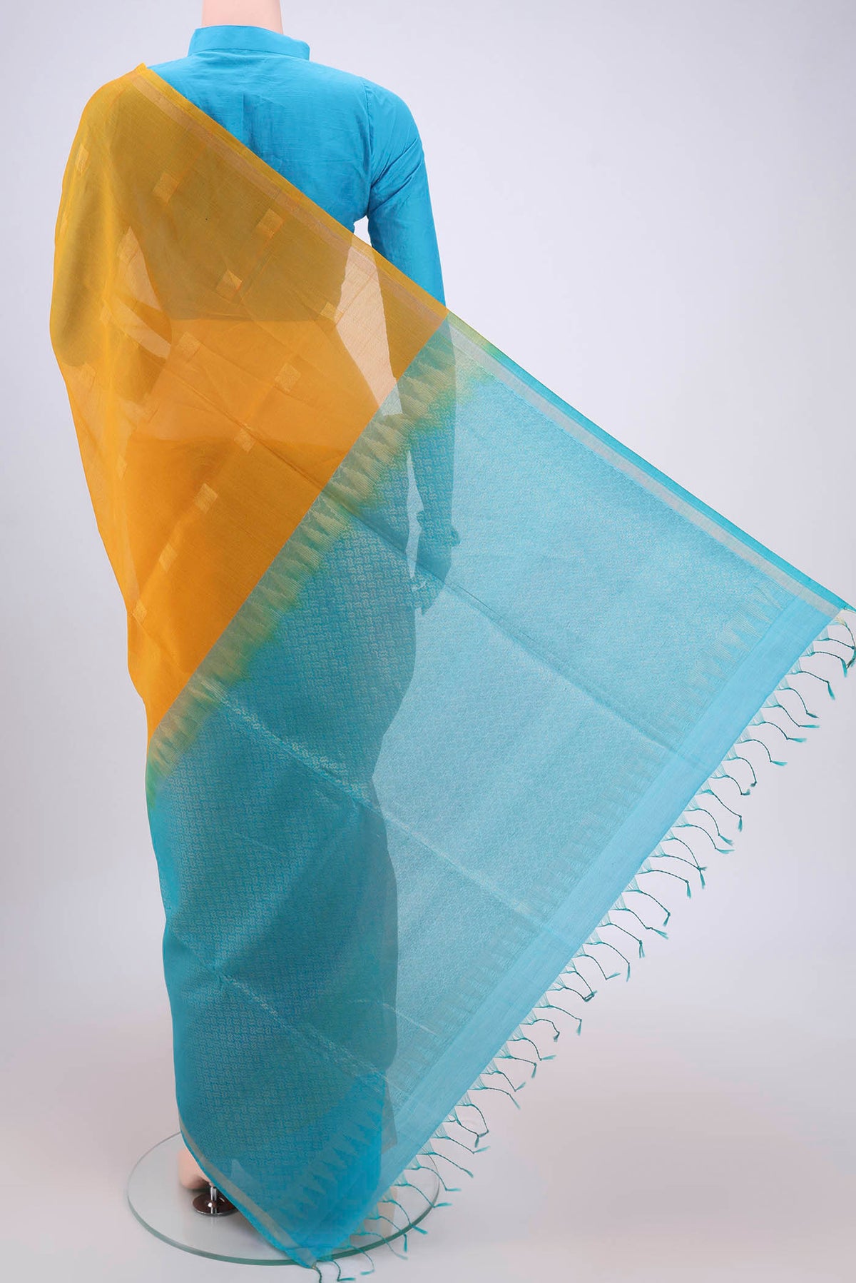 Flat view of Yellow Silk Cotton Saree with Zari Butta on the body and Thin Zari Line. 