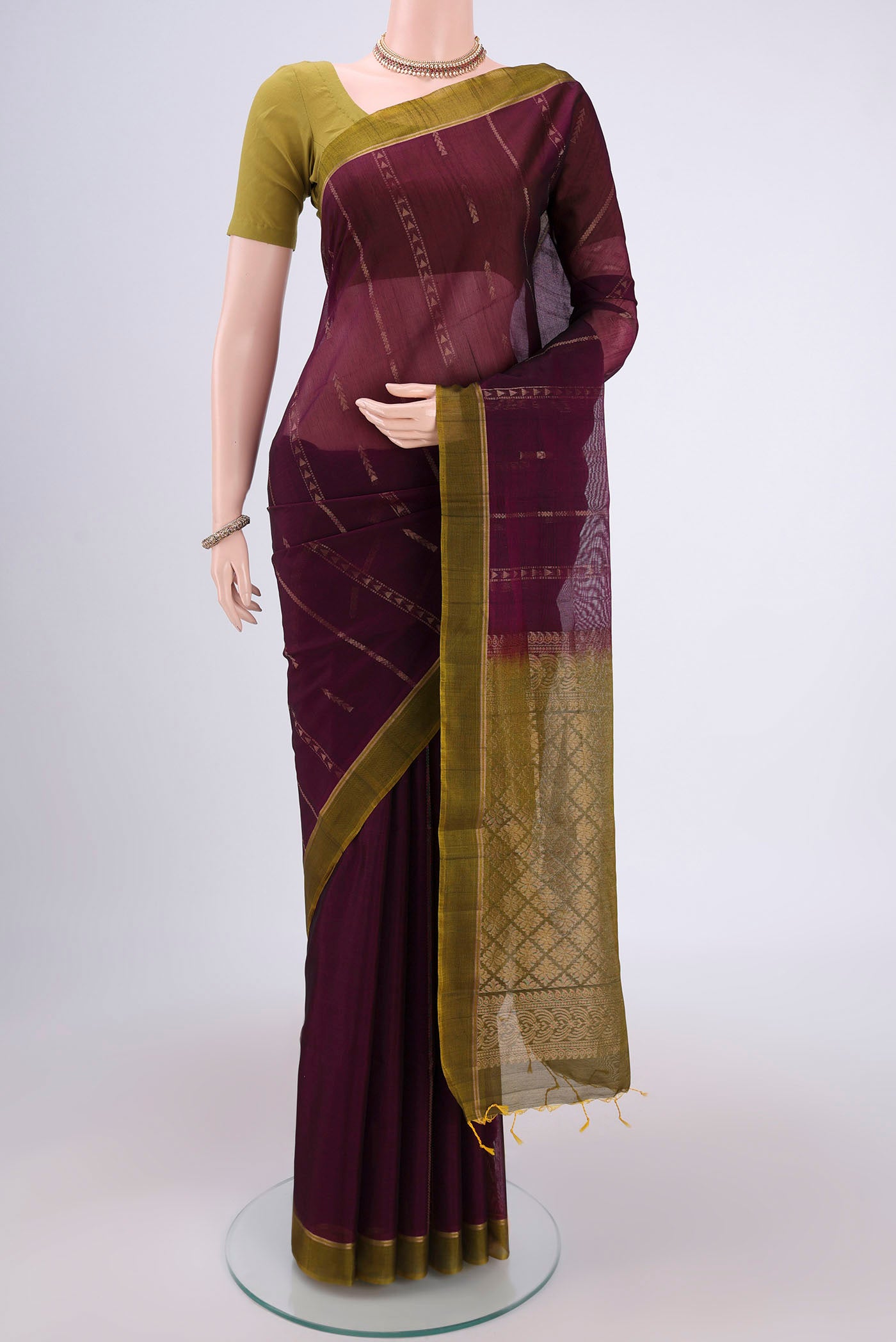 Magenta Silk Cotton Saree with Zari Butta on the body and Zari Border.  displayed on a mannequin