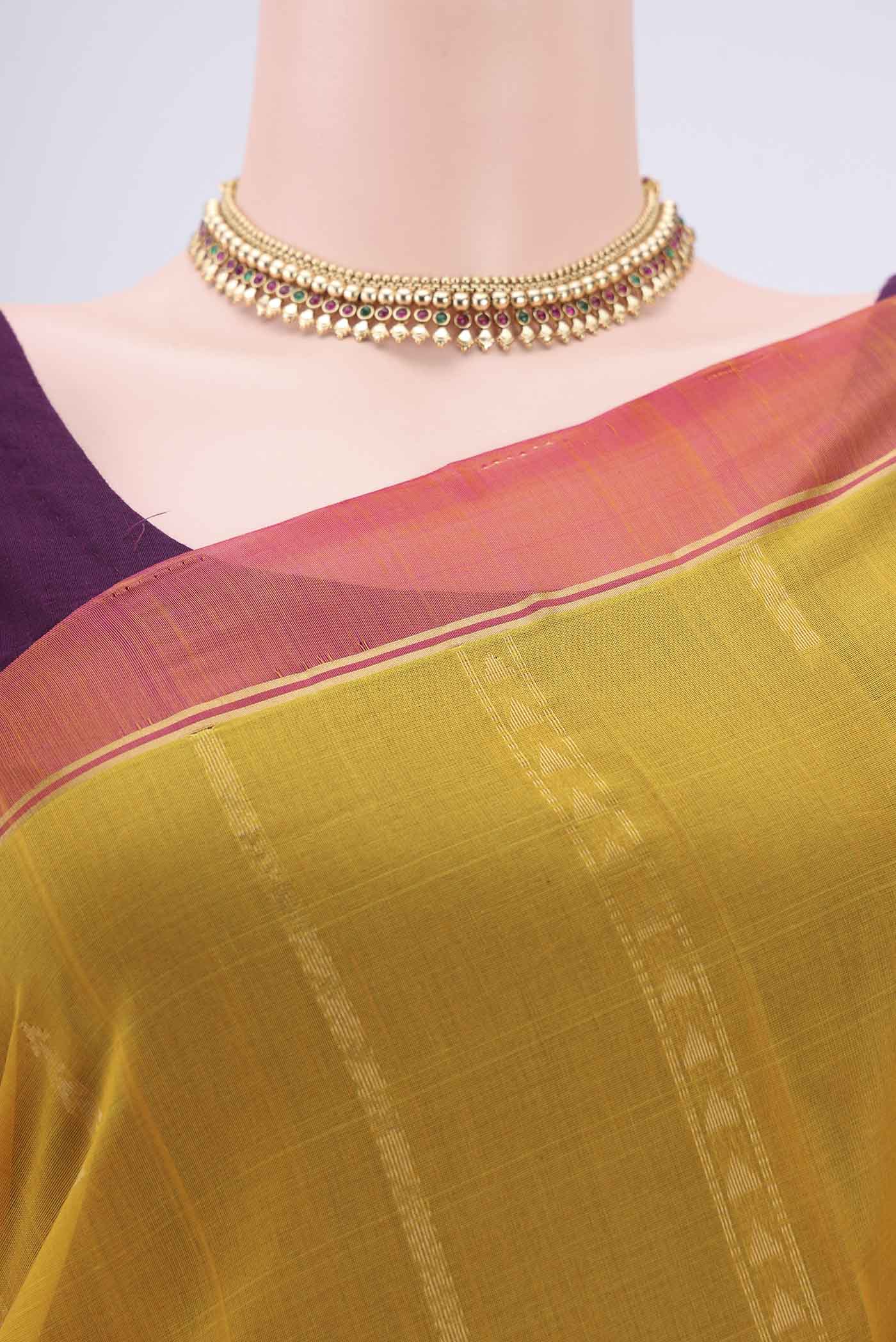 Border image of Yellow Silk Cotton Saree with Zari Butta on the body and Zari Border. 