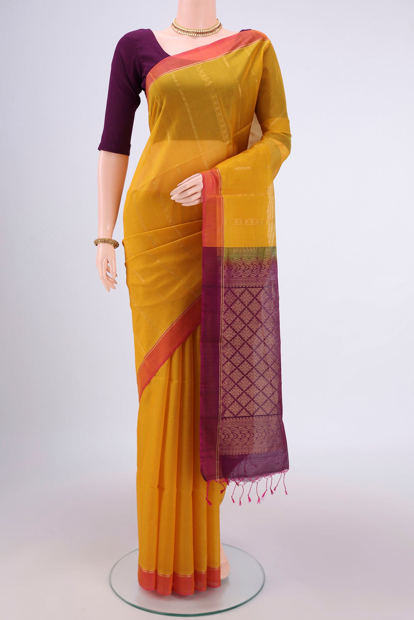 Yellow Silk Cotton Saree with Zari Butta on the body and Zari Border.  displayed on a mannequin