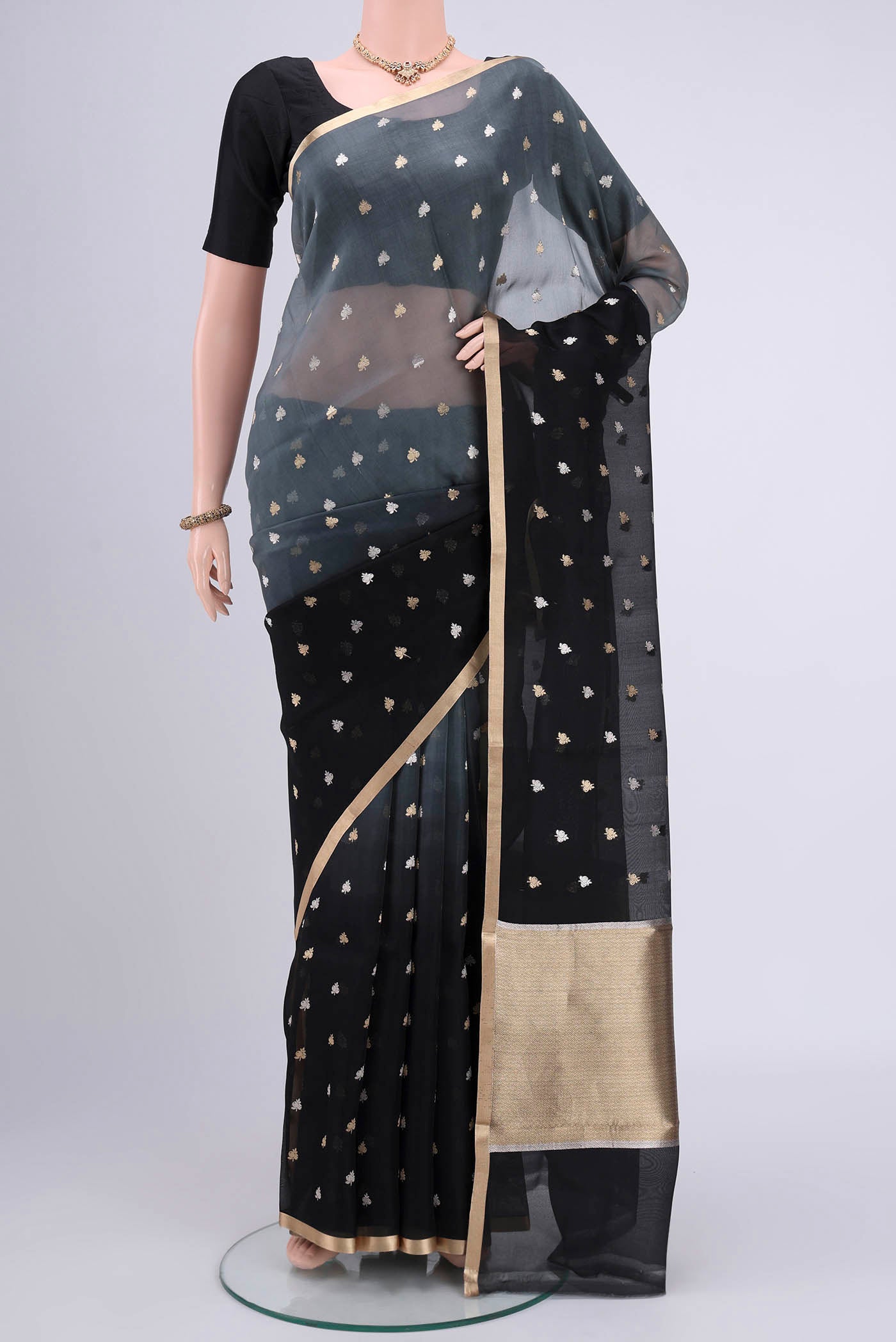 Davys Grey Organza Silk Saree with Half And Half on the body and Zari Border.  displayed on a mannequin