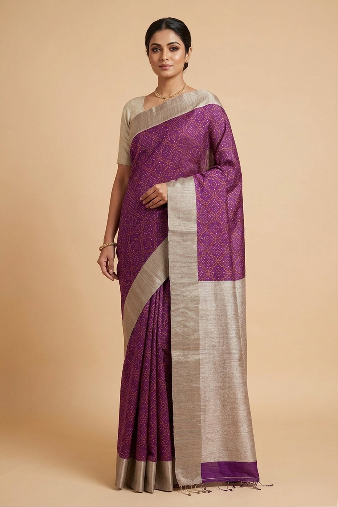 Model wearing a Purple Tussar Silk Saree with Bandhani Print on the body and Zari Border.