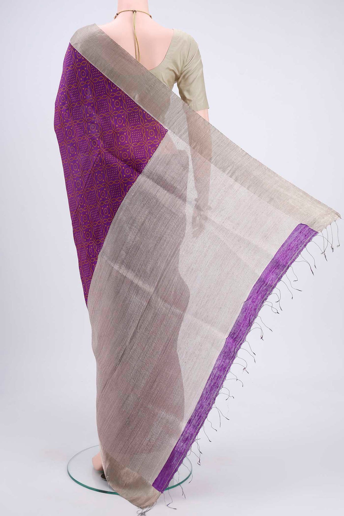 Flat view of Purple Tussar Silk Saree with Bandhani Print on the body and Zari Border. 