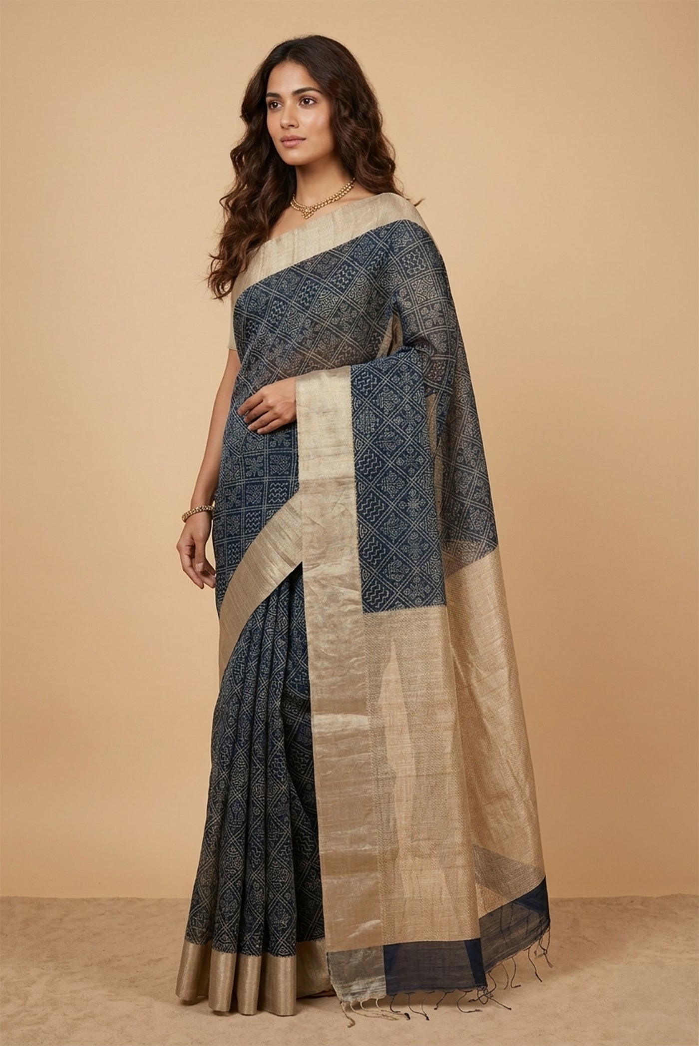 Model wearing a Navy Blue Tussar Silk Saree with Bandhani Print on the body and Zari Border.