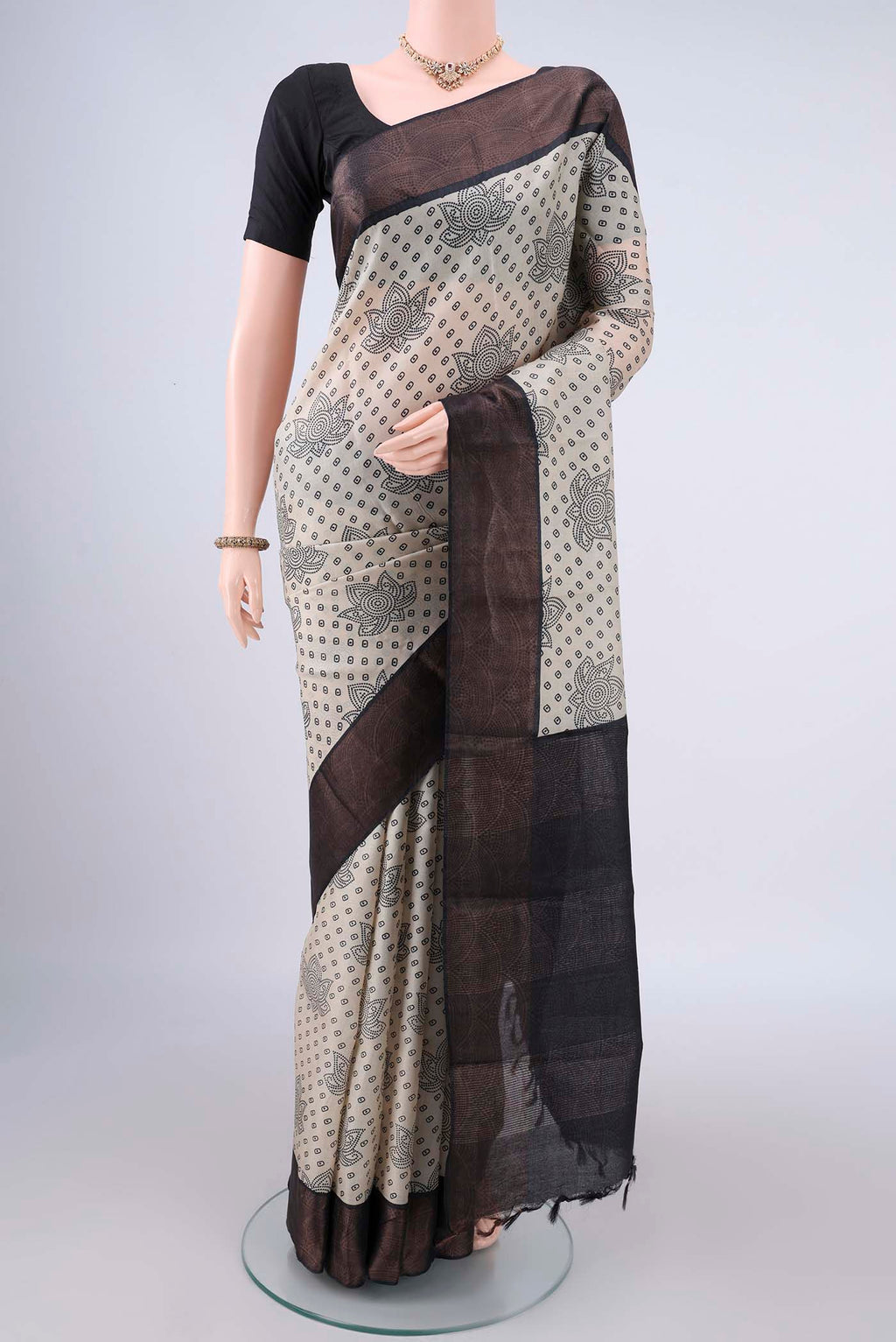 Cream Tussar Saree with Printed design on the body and Zari Border.  displayed on a mannequin