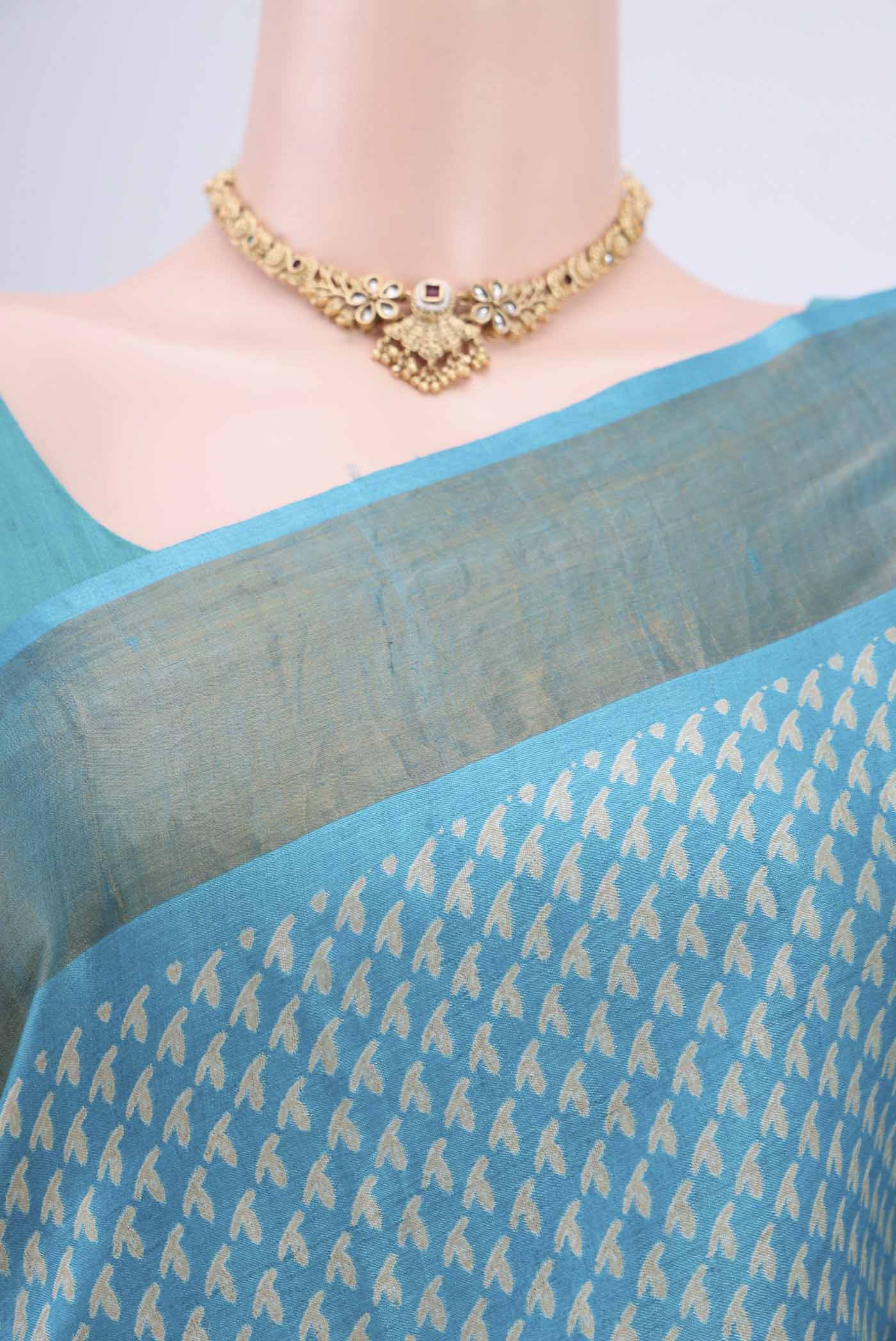 Border image of Turquoise Tussar Silk Saree with Printed design on the body and Zari Border. 
