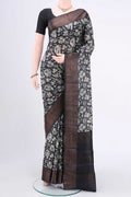 Black Printed Silk Saree with Floral Print on the body and Zari Border.  displayed on a mannequin