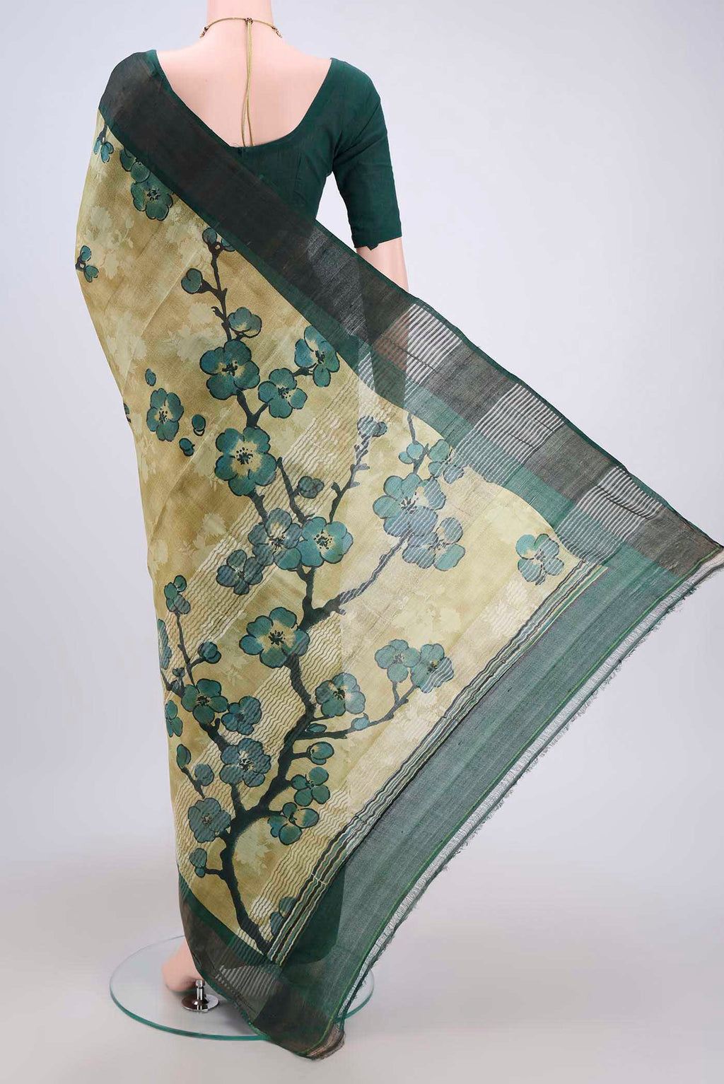 Flat view of Light Green Tussar Silk Saree with Printed design on the body and Zari Border. 