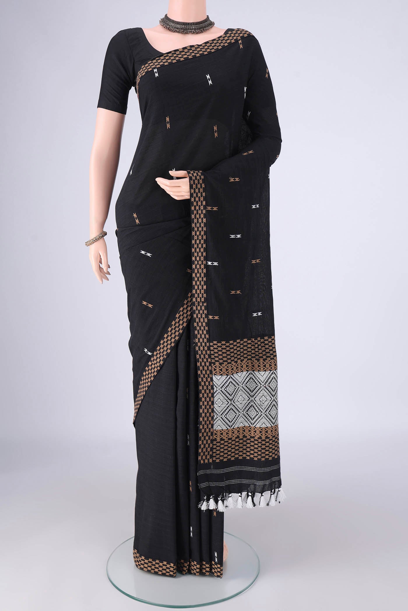 Black Assam Cotton Saree with Thread Butta on the body and Thread Border.  displayed on a mannequin
