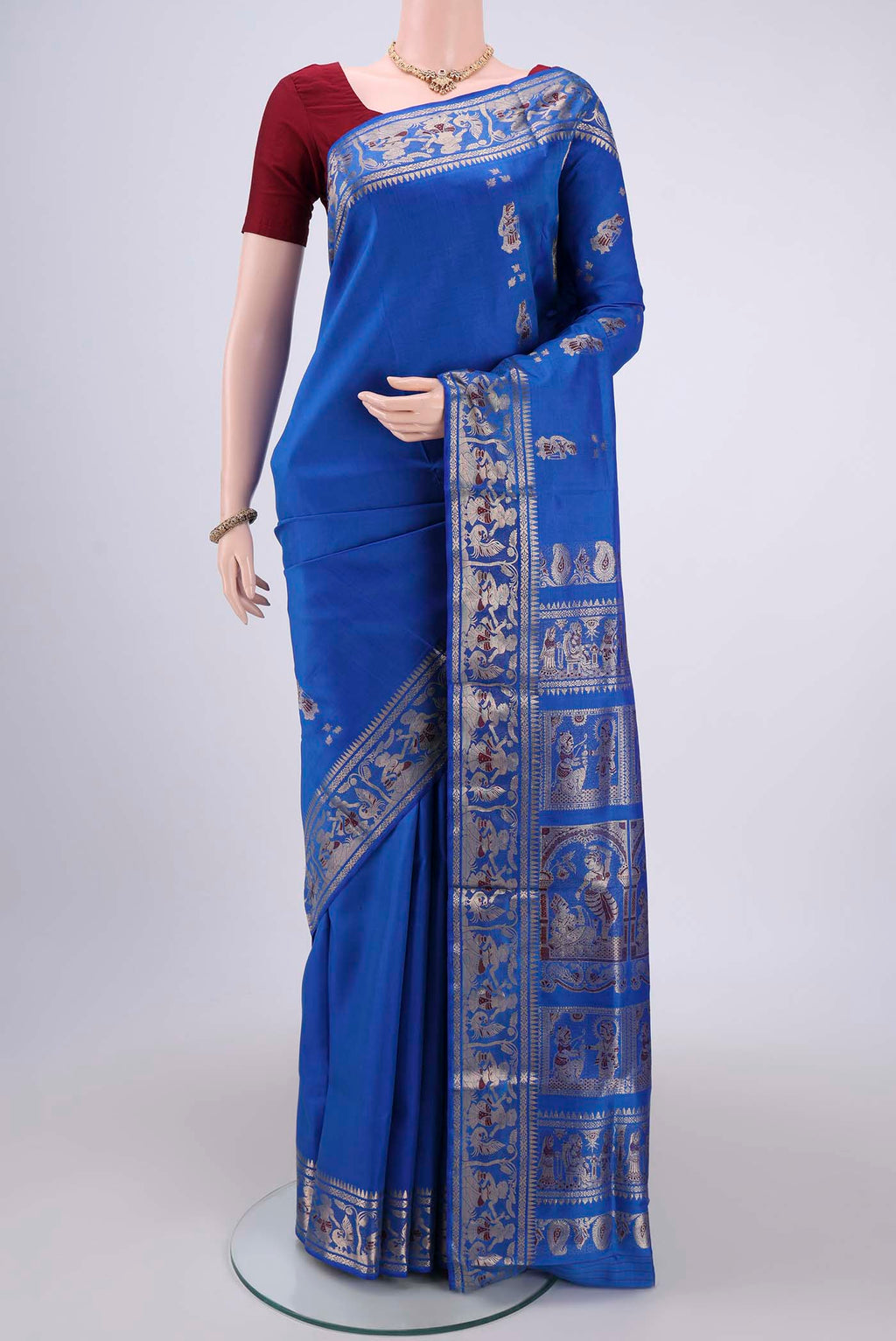 Royal Blue Baluchari Silk Saree with Zari And Thread Butta on the body and Zari And Thread Border.  displayed on a mannequin