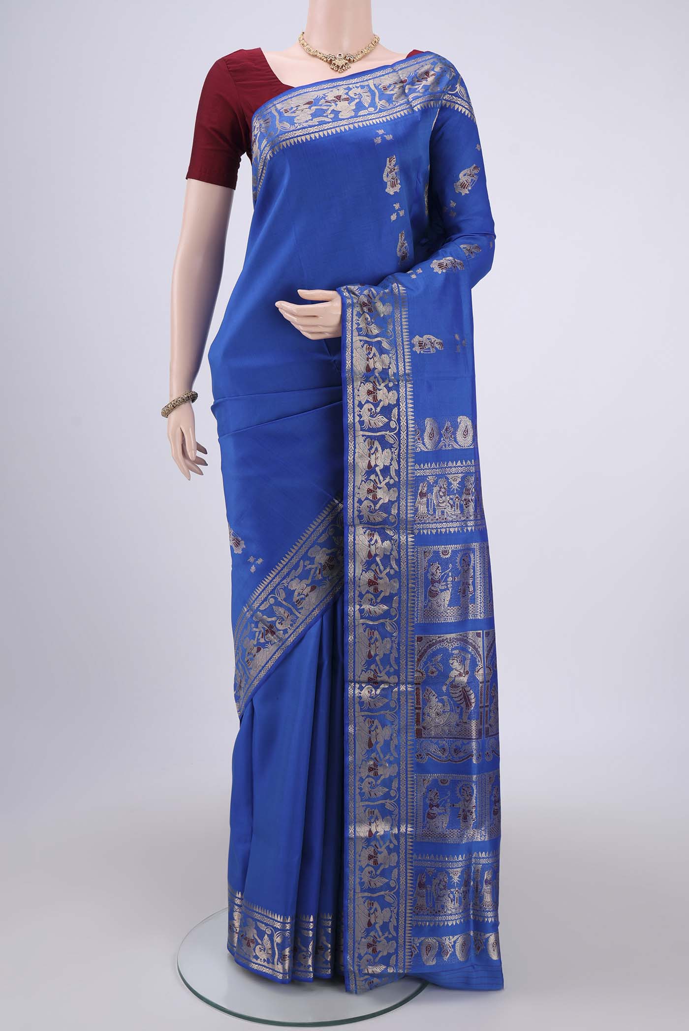Royal Blue Baluchari Silk Saree with Zari And Thread Butta on the body and Zari And Thread Border.  displayed on a mannequin