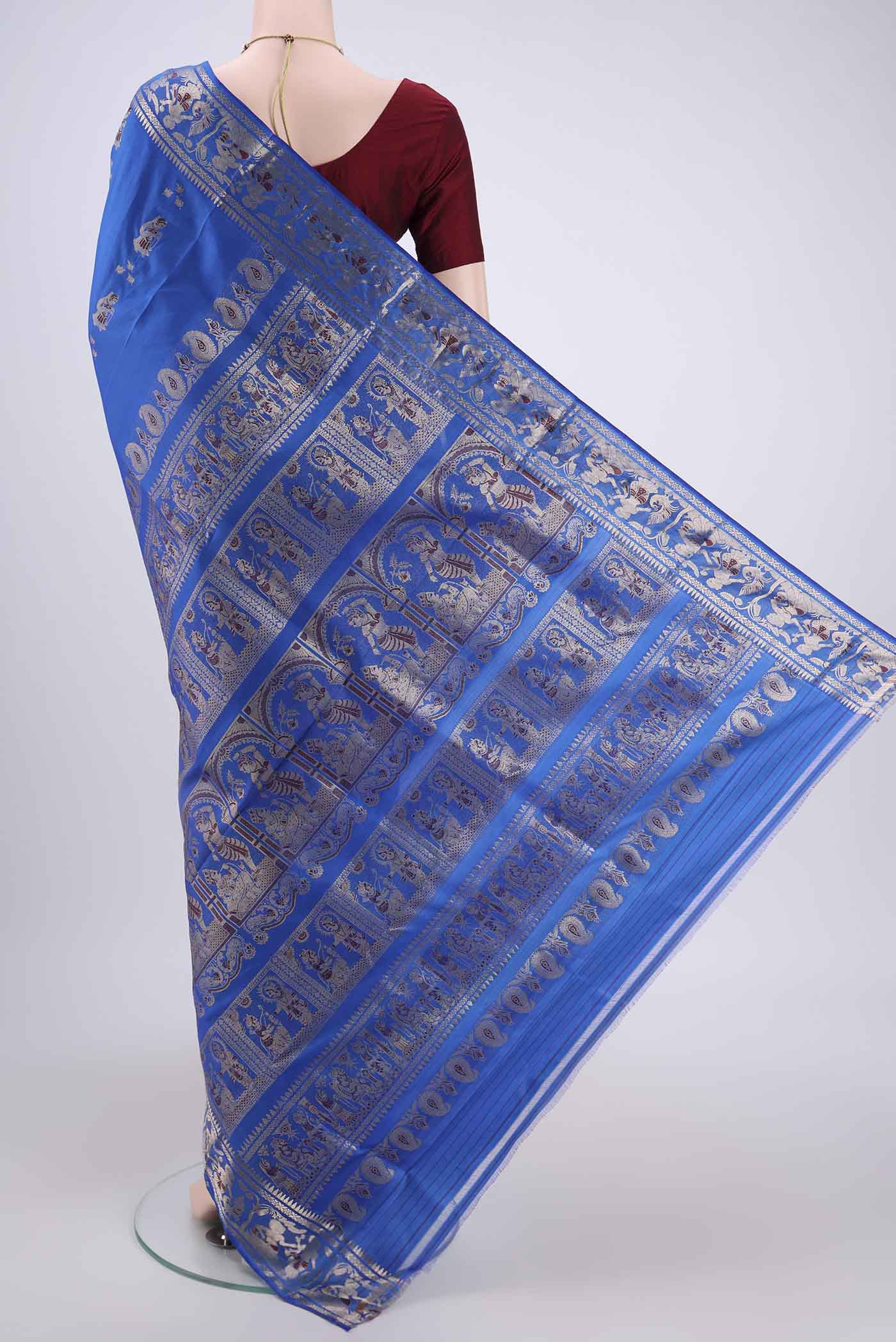 Flat view of Royal Blue Baluchari Silk Saree with Zari And Thread Butta on the body and Zari And Thread Border. 