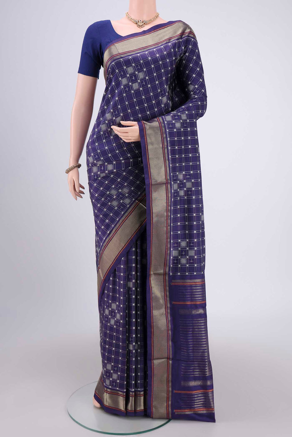 Purple Pochampally Silk Saree with Checked design on the body and Zari Border.  displayed on a mannequin