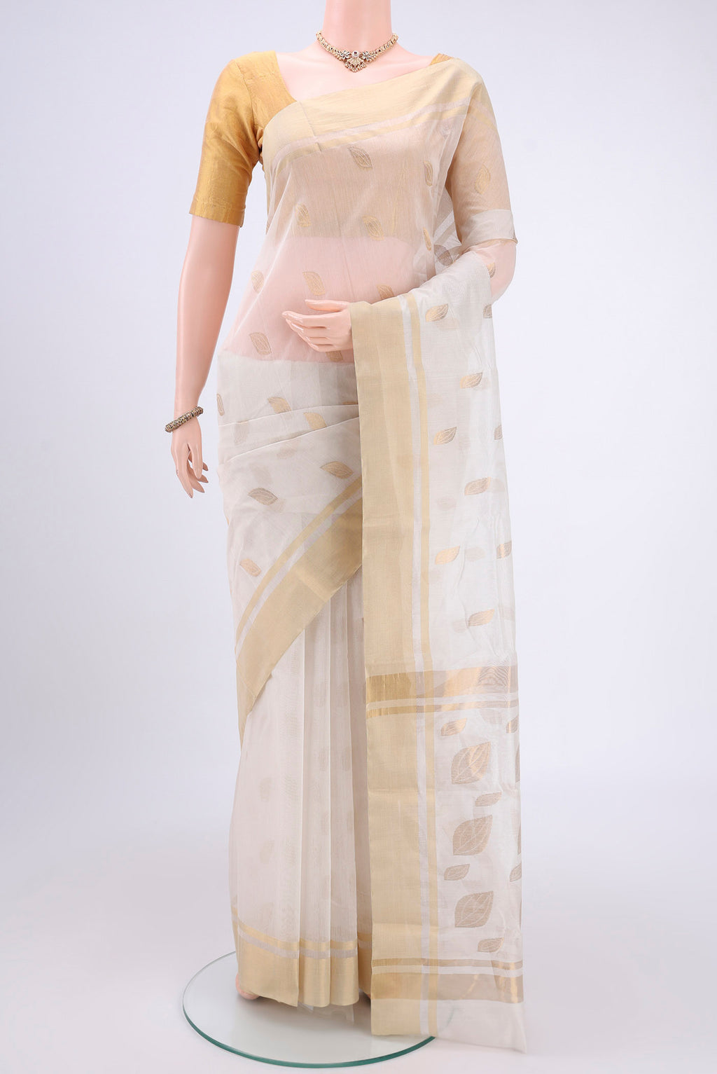 Pearl White Chanderi Silk Cotton Saree with Zari Butta on the body and Zari Border.  displayed on a mannequin