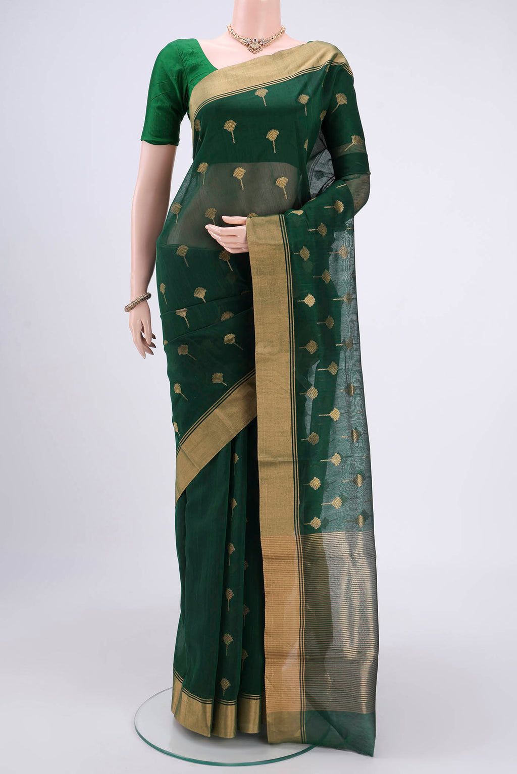 Green Chanderi Silk Cotton Saree with Zari Butta on the body and Zari Border.  displayed on a mannequin