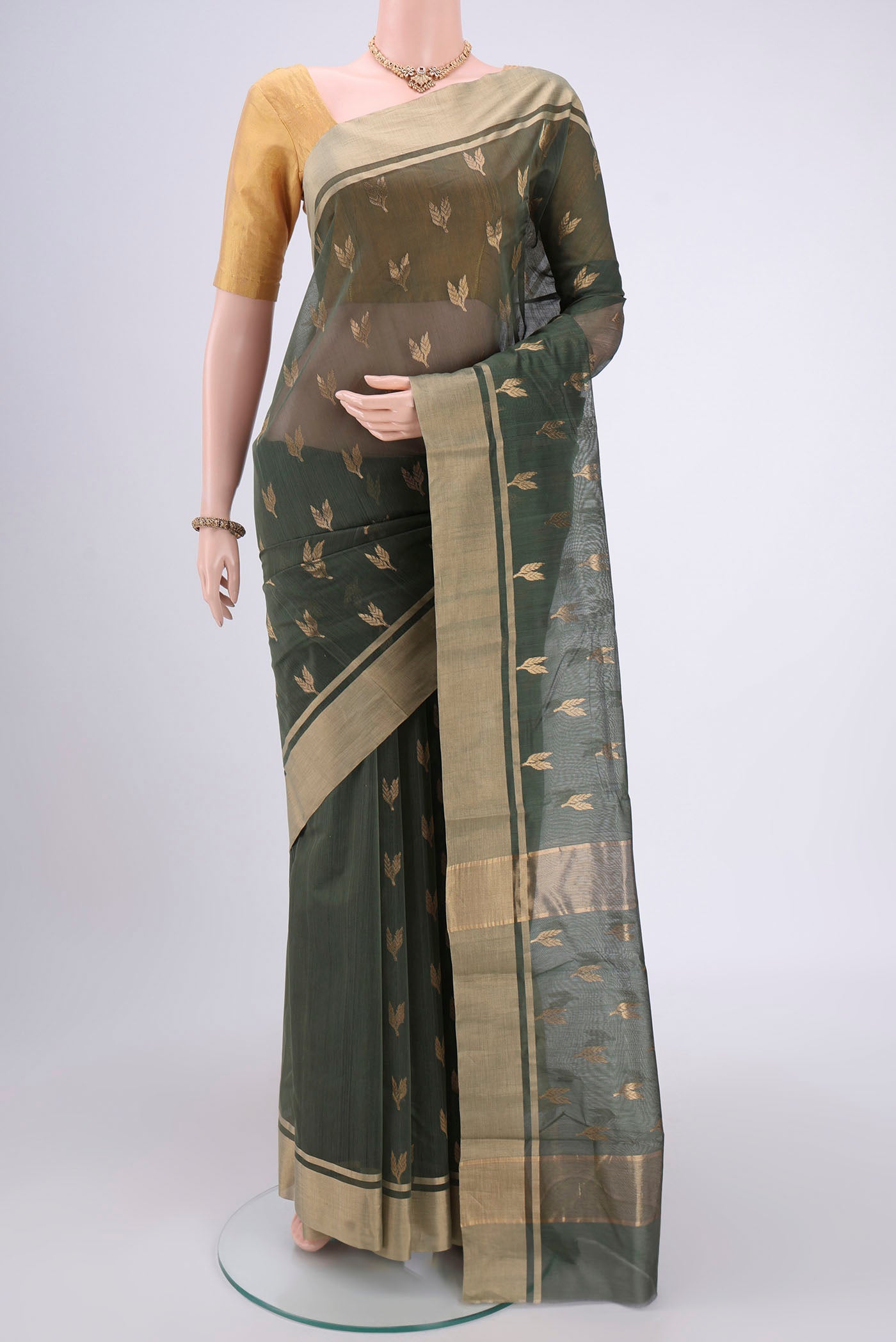 Sage Green Chanderi Silk Cotton Saree with Zari Butta on the body and Zari Border.  displayed on a mannequin